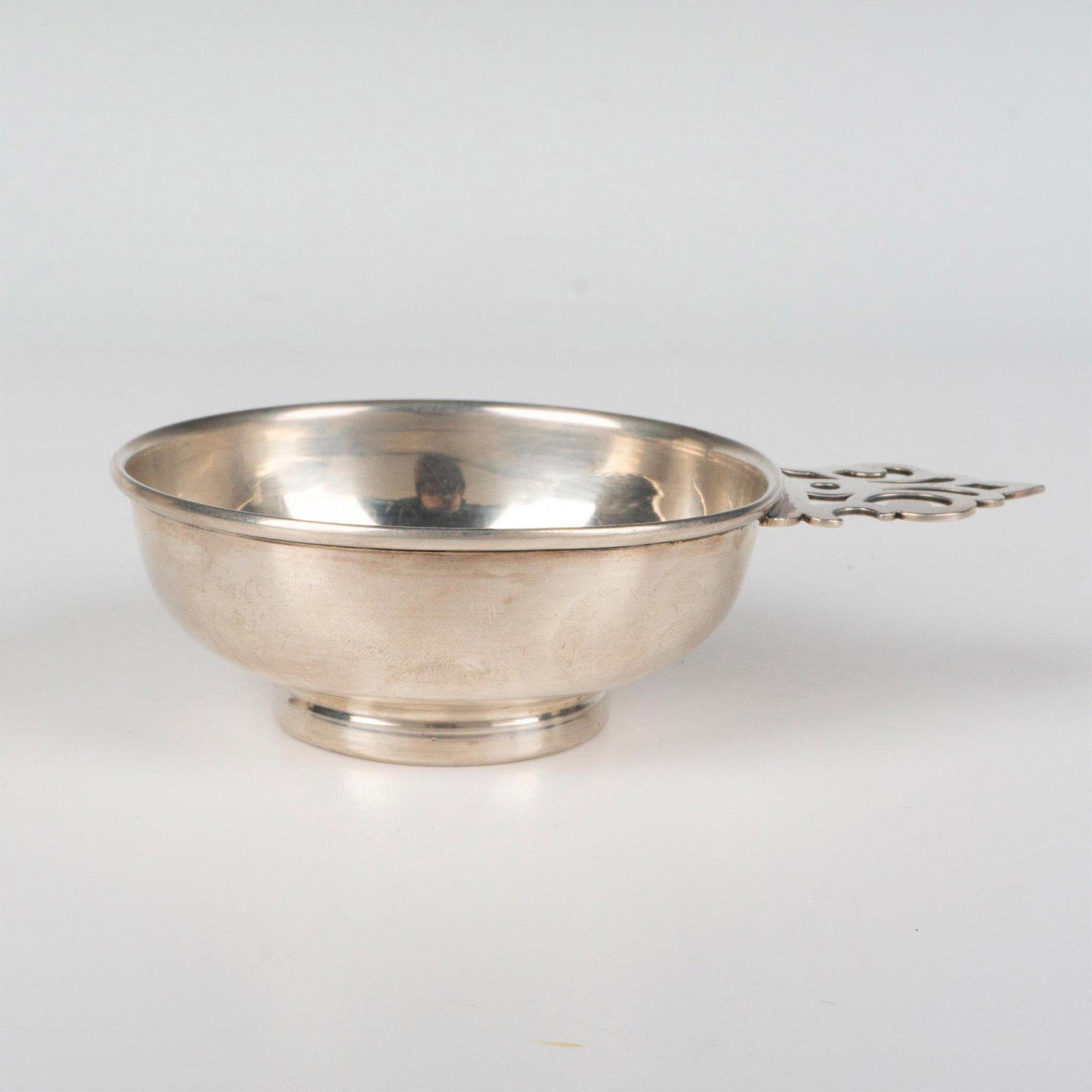 Cartier Sterling Silver Handled Dish with French Medal Base: An antique porringer or wine tasting cup by Cartier. Ornate handle and medal commemorating the General Headquarters at Osterode 1807 as a bottom. Medal depicts Fabius and Napoleon I on the other side.