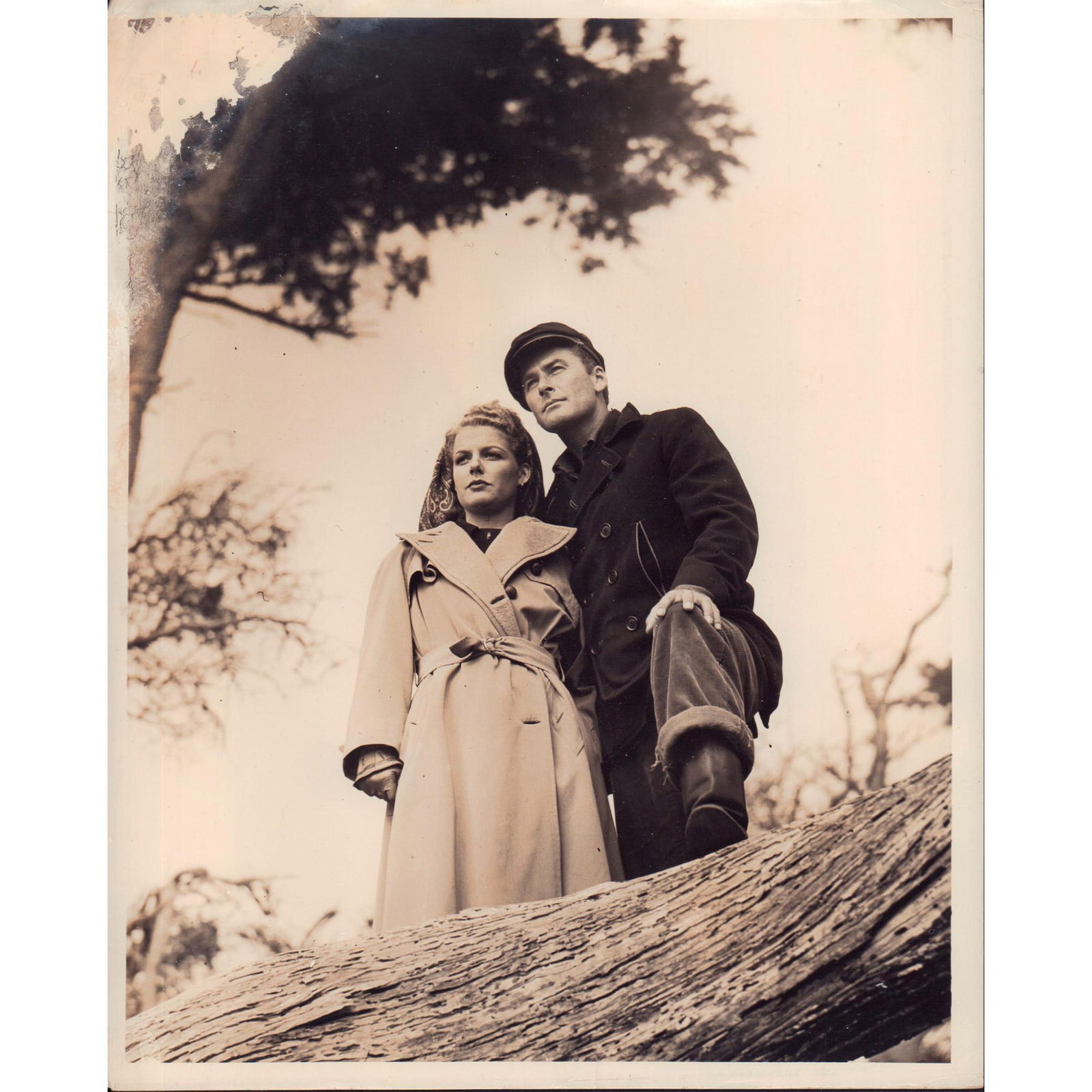 Photograph From Edge of Darkness, Actors: Black and white photo of a scene from film "Edge of Darkness", featuring Ann Sheridan and Errol Flynn. 'Ann Sheridan, Errol Flynn in Edge of Darkness (4x5) A Warner Bros. First National Picture' glued