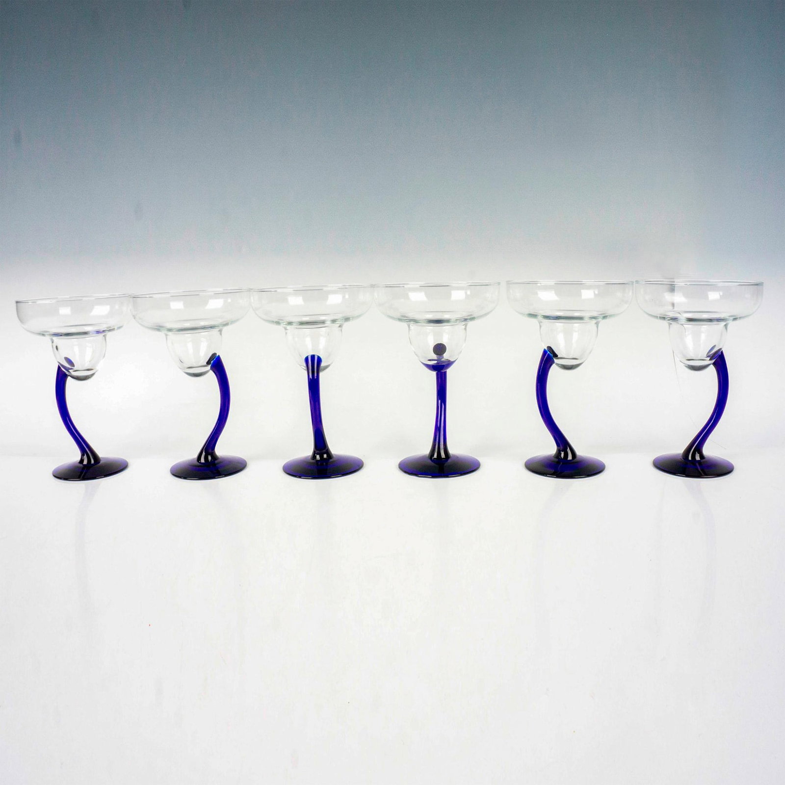 6pc Libbey Bravura Margarita Glasses: Six cocktail glasses with stylish curved cobalt blue stems. Dimensions: 7.25"H x 4.75"Dia