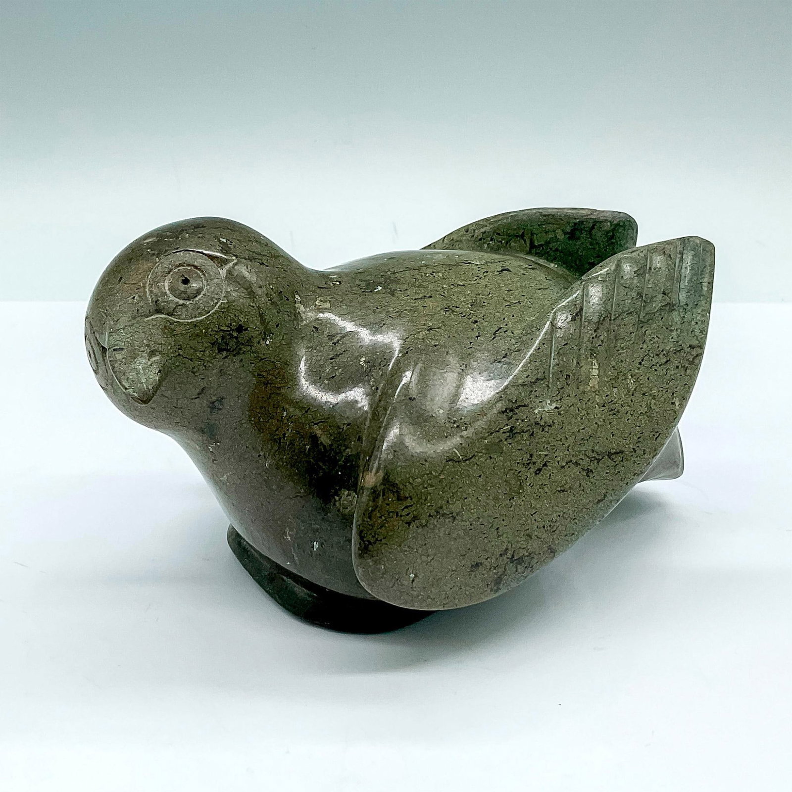 Seepee Ipeelie (Canadian, 1940-2000) Sculpture, Bird: Polished soapstone sculpture of a rotund little bird with minimal features and Seepee Ipeelie's distinct bullseye-style carved eyes. Artist's name is inscribed in syllabic characters to base. Seepee I