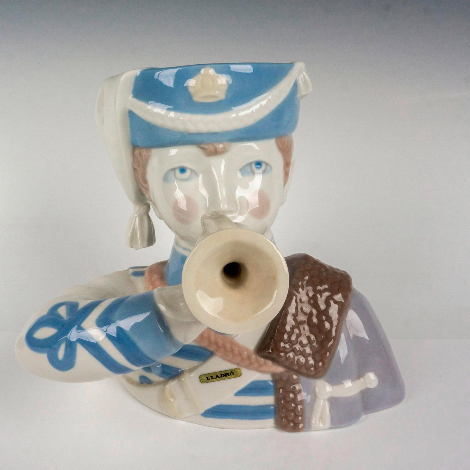 Boy With Cornet 1001105 - Lladro Porcelain Figurine: Glossy finish; Lladro backstamp. Artist: Julio Fernandez Issued: 1971 - 1973 Dimensions: 8.25"H Manufacturer: Lladro Country of Origin: Spain