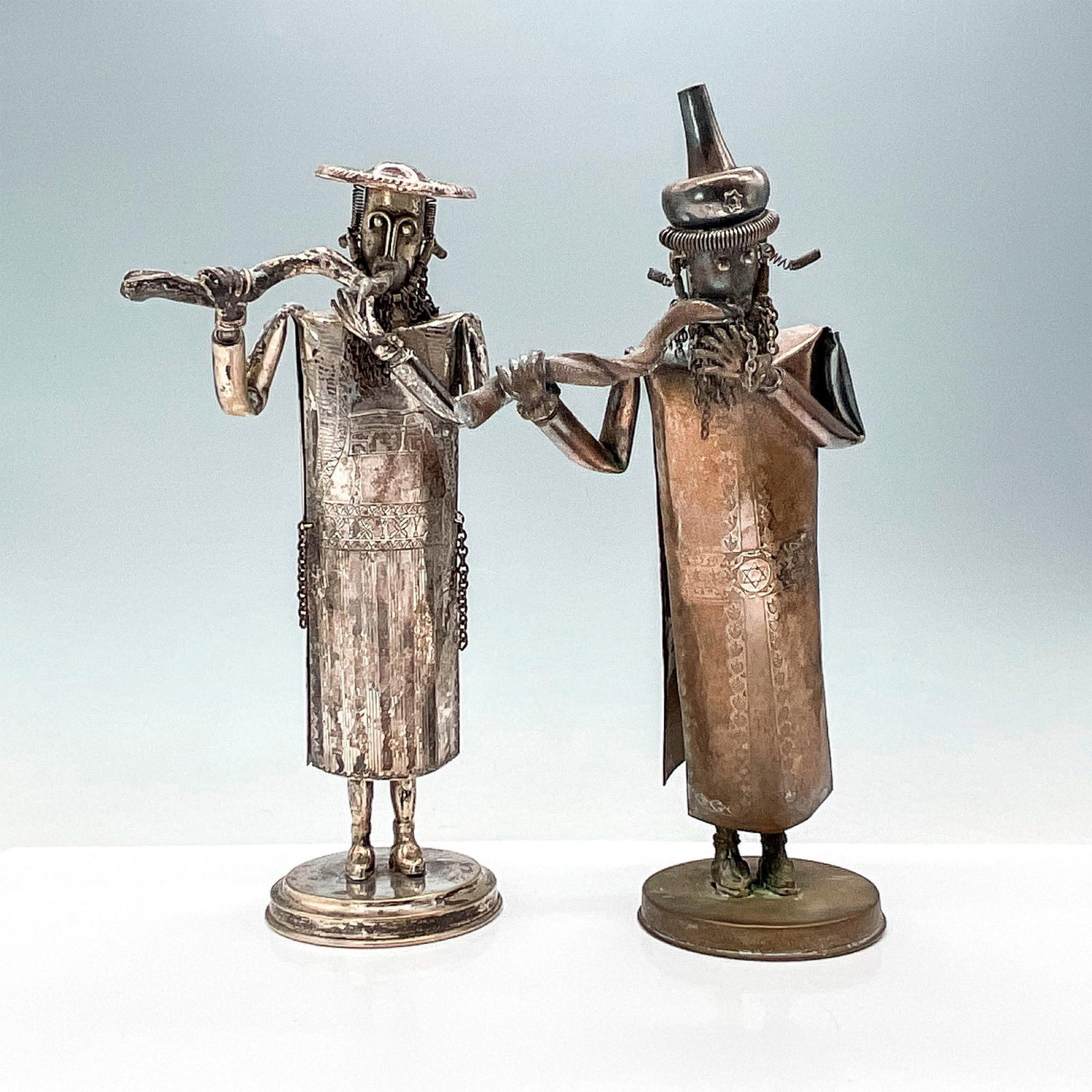 Pair of Silver Shlomo Ohana Judaica Figurines: Two original hand-made figurines of Jewish men playing musical instruments. A spring hidden inside allows the figurines to move back and forth. The surface is decorated with embossed patterns. Hair an