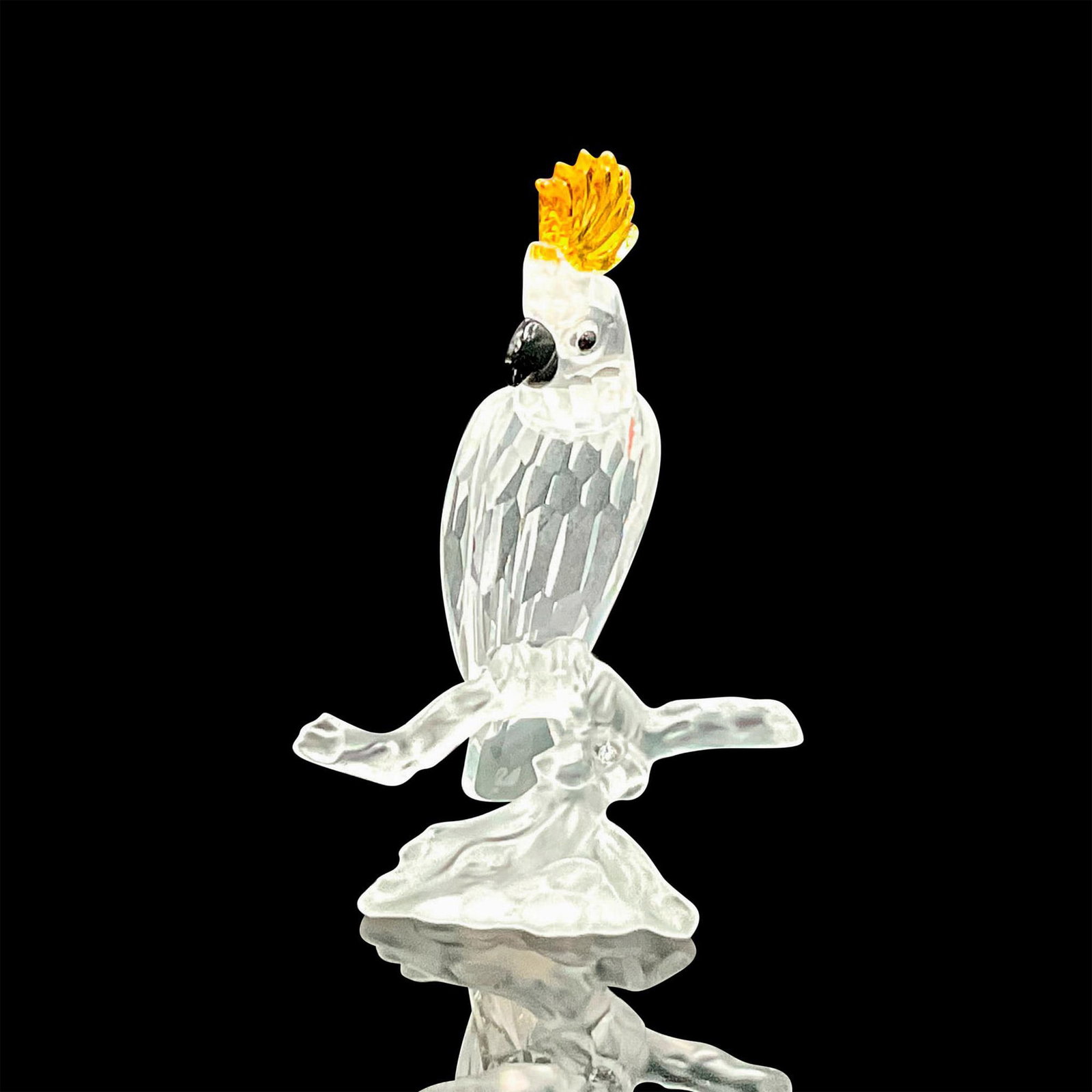 Swarovski Silver Crystal Figurine, Cockatoo: Part of the 'Feathered Friends' and 'Feathered Beauties' collections. Clear faceted crystal body with a black beak and eyes, and yellow crown. Swarovski marking. This item has its original box: 3.25"W