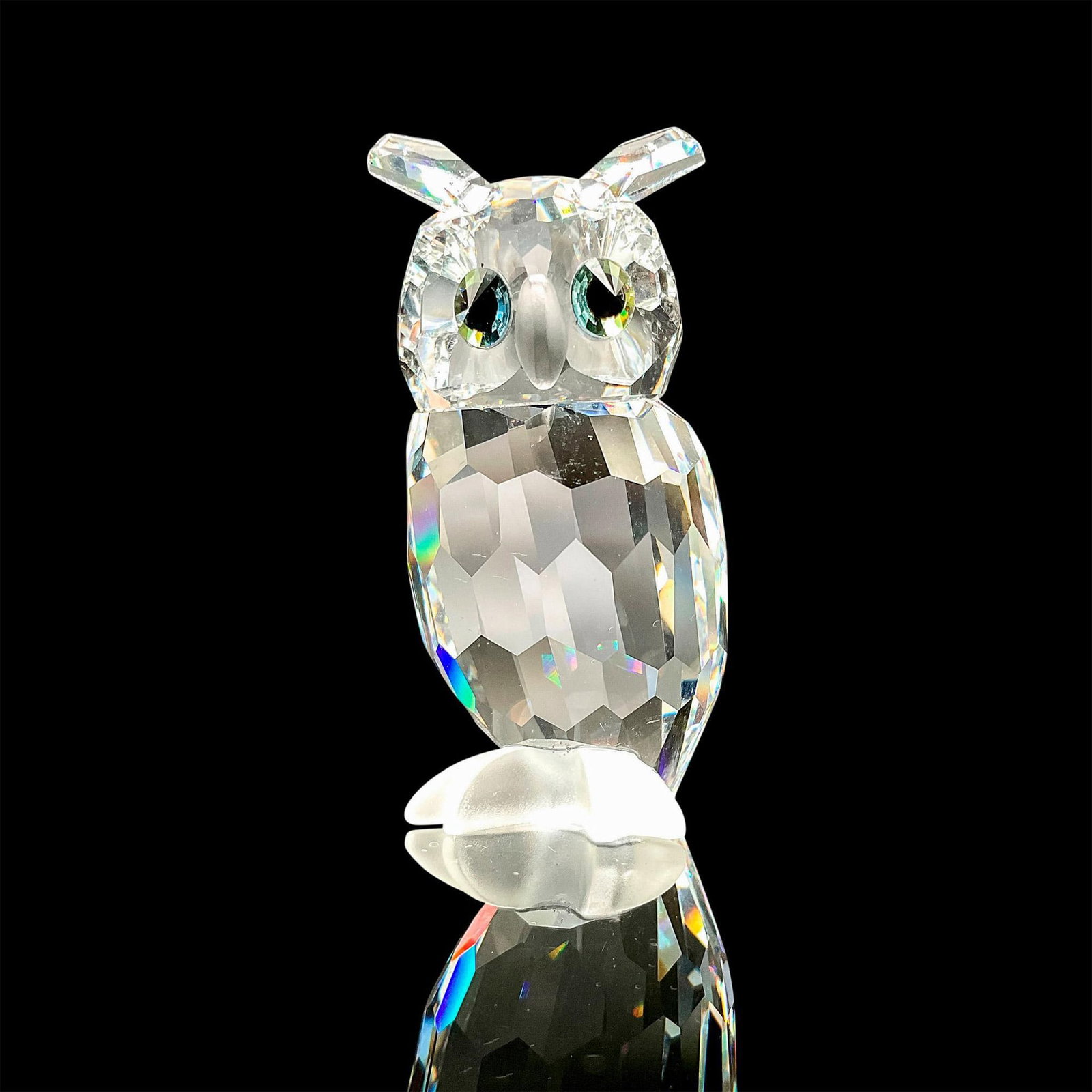 Swarovski Silver Crystal Figurine, Owl: Gorgeous faceted crystal figurine modeled as a horned owl with blue green gem eyes and frosted feet. Swarovski acid marks. This item has its original box. Box dimensions: 3.25"W x 4.5"H. Dimensions: 0
