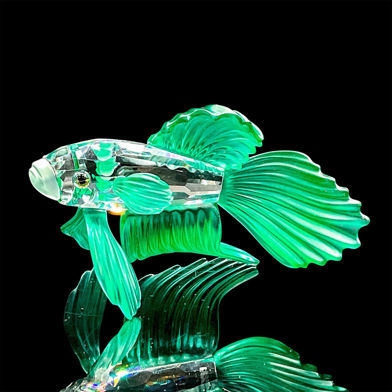Swarovski Crystal Figurine, Siamese Fighting Fish Green: Sparkling clear silver crystal figure of a fish with green fins and tail. Swarovski etched backstamp. Includes original box 4"H x 4.75" dia. Certificate of Authenticity included. Dimensions: 3"L x 2.7