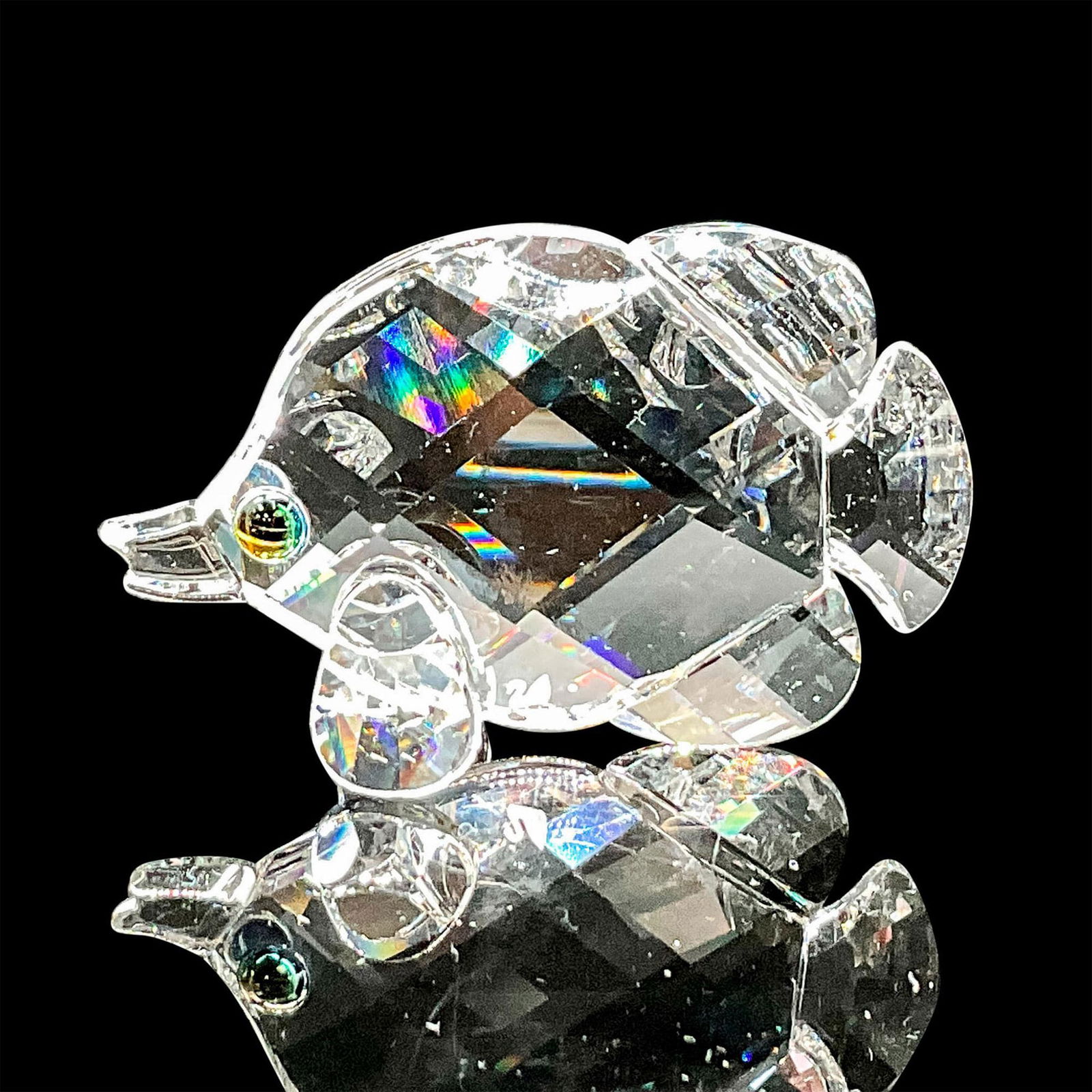 Swarovski Crystal Figurine, Butterfly Fish: Dazzling clear crystal figure of a fish with blue/green eyes. Swarovski etched backstamp. Includes original box 2.5"H x 3.25" dia. Dimensions: 2"L x 0.75"W x 1.5"H Manufacturer: Swarovski Country of O