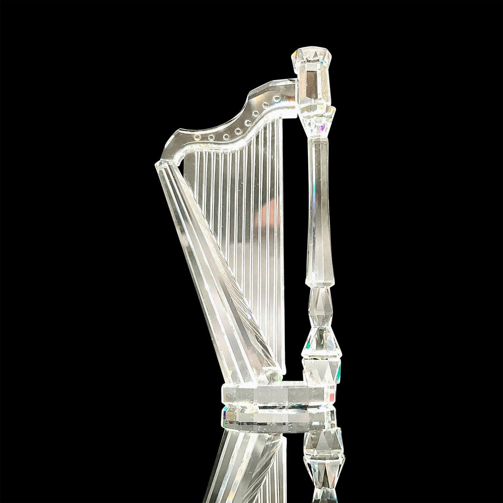 Swarovski Silver Crystal Figurine, Pedal Harp: Sparkling faceted and molded crystal figurine modeled as a pedal harp. Swarovski acid marks. This item has its original box. Box dimensions: 6"H x 5"dia.. Dimensions: 2"L x 1"W x 4"H Manufacturer: Swa