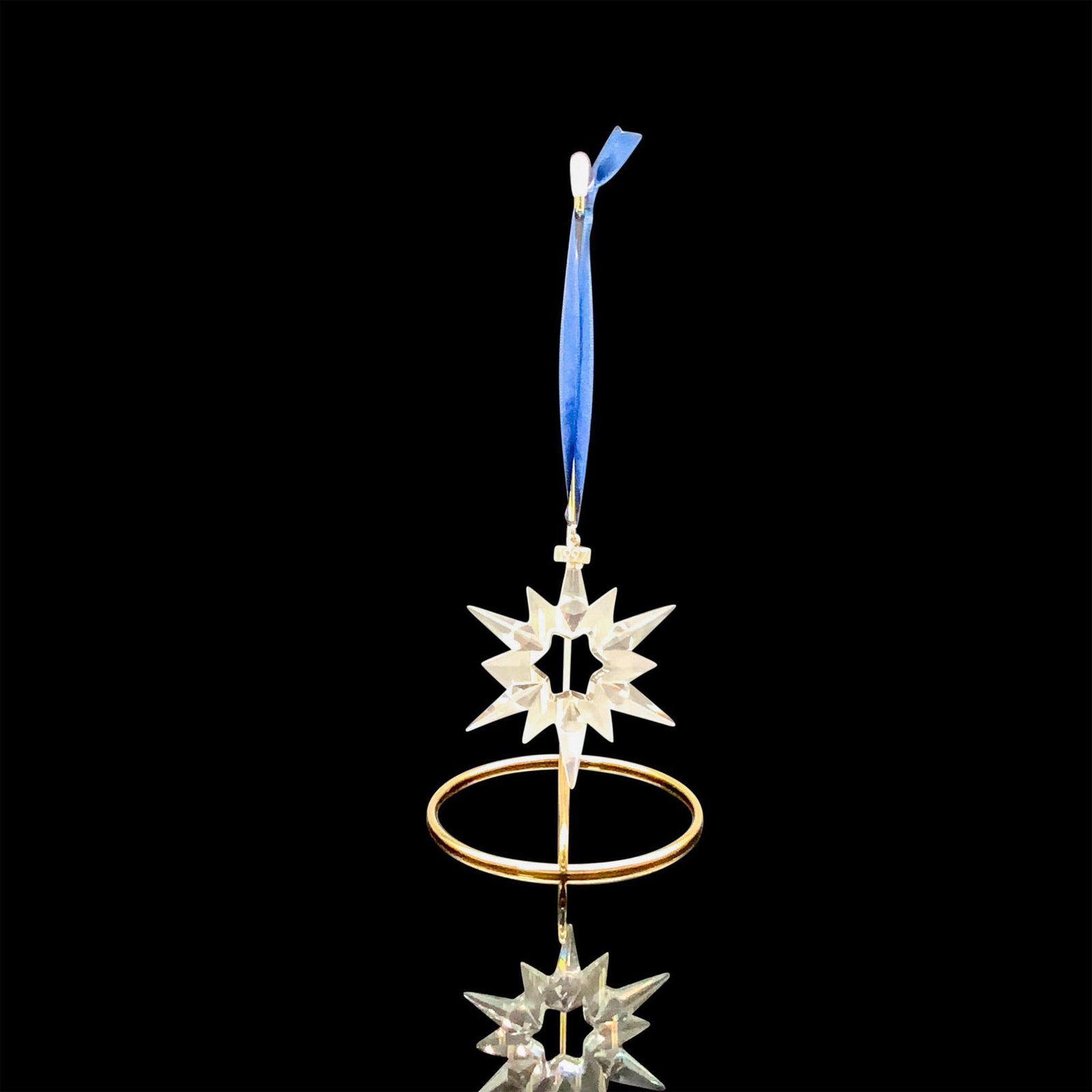 Swarovski Crystal Christmas Ornament, Star 1997: A clear crystal ornament that is in the shape of a star with multiple pointed with a metal key tag that has 1997 imprinted on it. Swarovski backstamp. This item has its original box. Dimensions of the