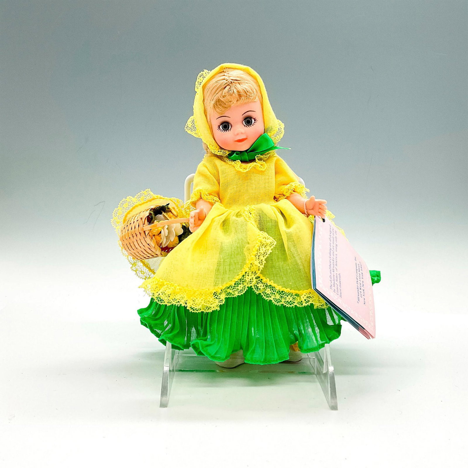 Madame Alexander Company Plastic Doll, Daffy Down Billy: Doll is dressed in a yellow and green dress and carries a basket of flowers. This item has a base included. This item has its original box. Box measures: 8.25"L x 8.25"W x 3.5"H. Dimensions: 6.25"L x 