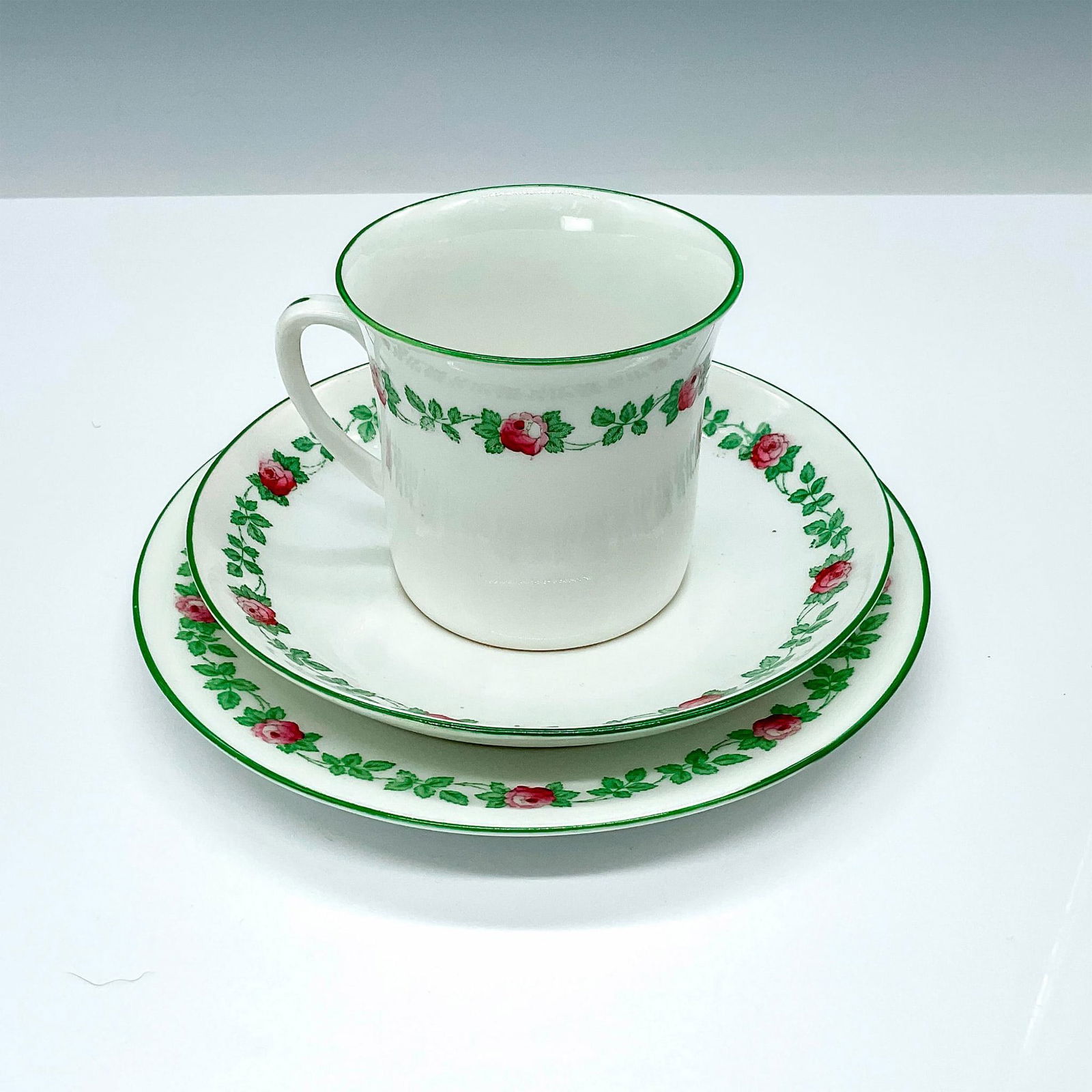 3pc Foley Art China Cup Saucer and Plate: Elegant fine bone porcelain China cup with its saucer and luncheon plate. Adorned with beautiful pink-red colored roses with green vine pattern. Backstamped Frederick Gorringe Ltd. Foley Art China Buc