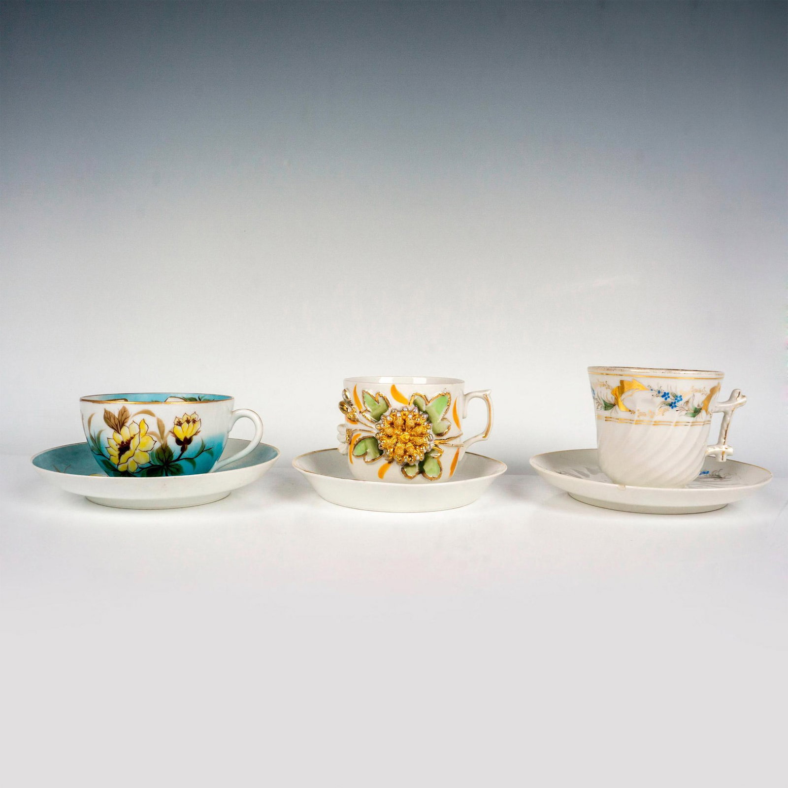 3pc Hand Painted Mustache Cups with Saucers: Hand painted porcelain mustache cups paired with their matching saucers. Largest piece measures 1"H x 6.75"dia. Issued: 20th Century