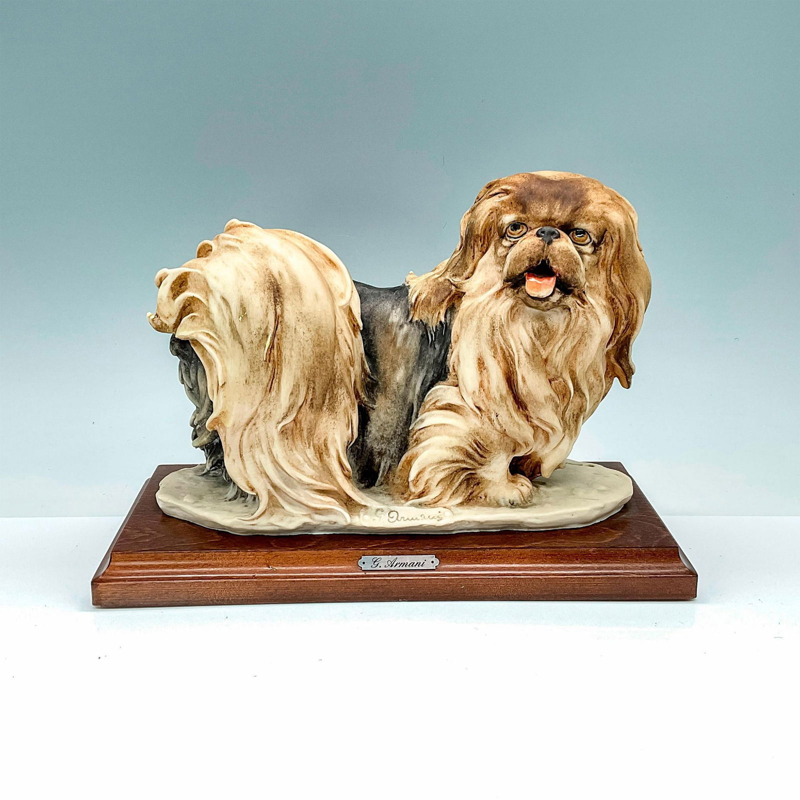 Florence Giuseppe Armani Figurine, Pekinese: This dog figurine depicts an adorable Pekingese, capturing the charm and personality of this beloved breed. This figurine is attached to a wooden base. Florence stamped into the base. Capodimonte back