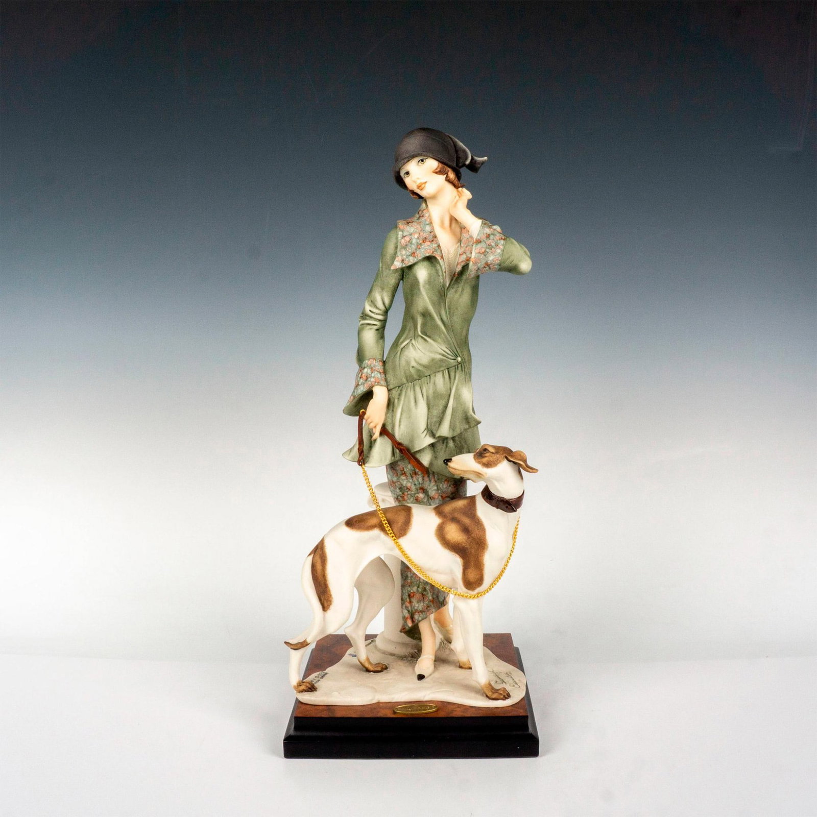 Florence Giuseppe Armani Figurine, Lady with Borzoi: Captivating figurine of lady in flapper era dress with her elegant yet bewildered dog. Giuseppe Armani embossed to base. 1992 Florence stamped into base with Capodimonte mark. This item has its origin
