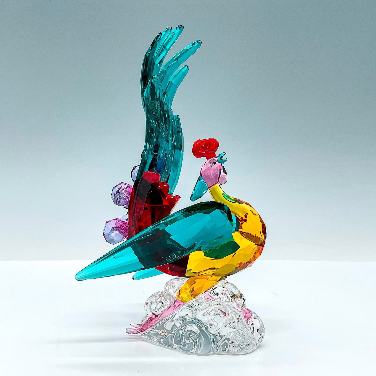 Swarovski Crystal Figurine, Elysian Phoenix: An Asian-inspired design, the phoenix shimmers in a variety of sumptuous crystal colors such as Siam, Medium Topaz, and Fuchsia Rain, and stands on a clear crystal base. A strongly symbolic and sparkl