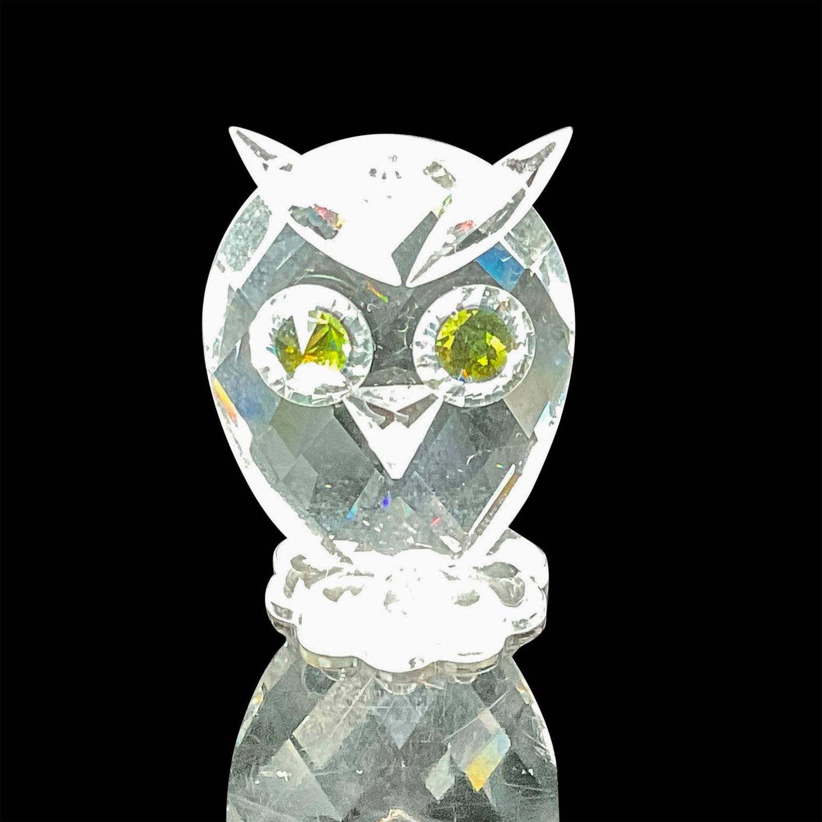 Swarovski Crystal Figurine, Owl Miniature: From the Feathered Beauties theme group, this wise little bird showcases a clear faceted crystal body and captivating big green eyes that appear to change color in different lighting This item has its