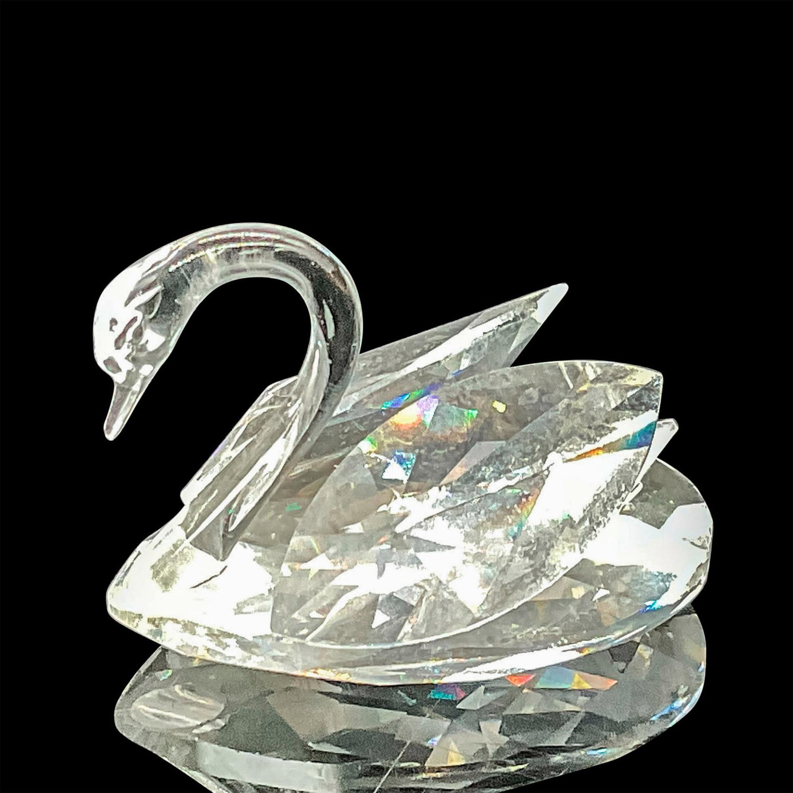 Swarovski Crystal Figurine, Swan Mini: This small-sized piece holds significant value among collectors, cherished for its rarity and exclusivity as a gala dinner gift. This item has its original box with measurements 2.5"L x 3"dia. Swarovs