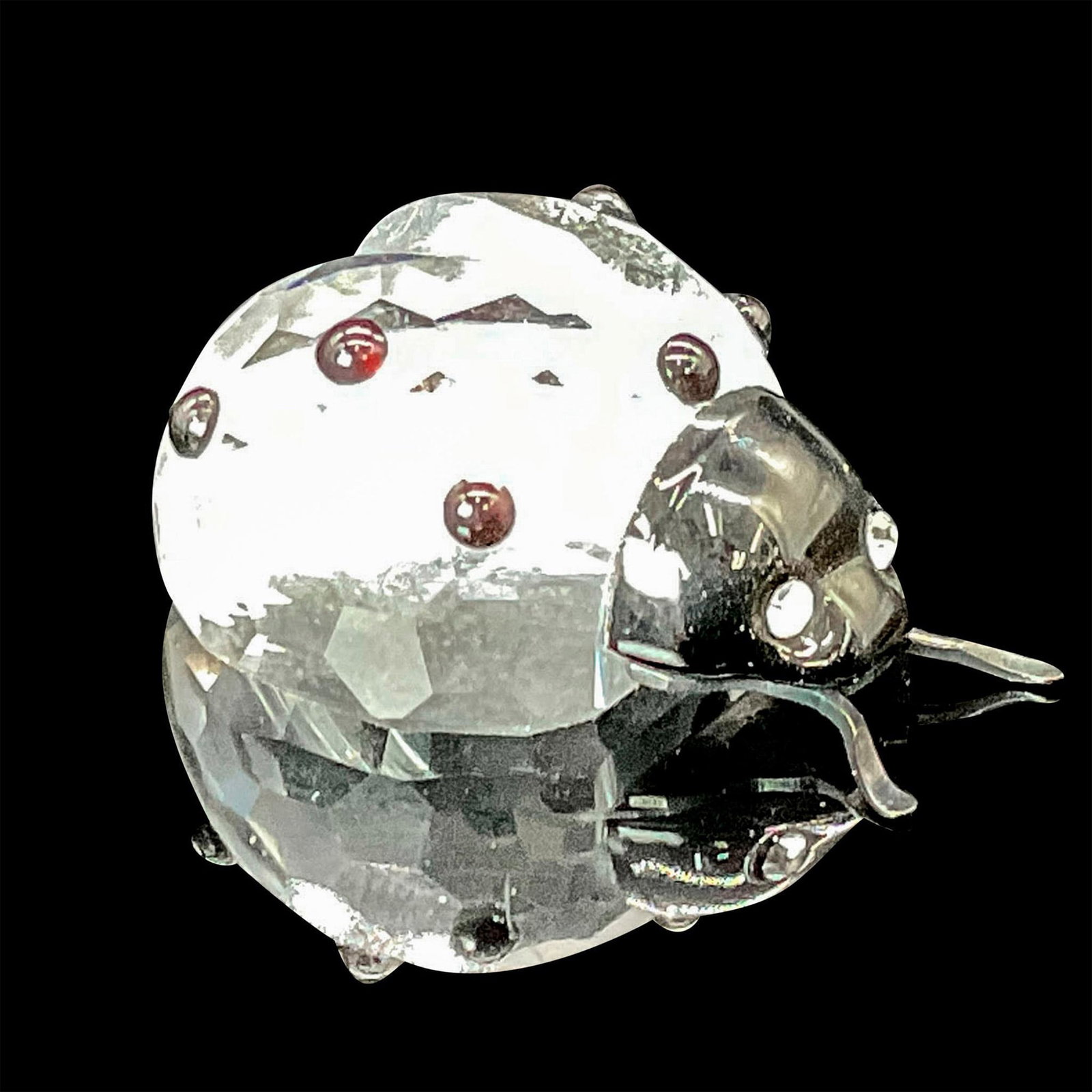 Swarovski Crystal Figurine, Ladybug Mini: This charming ladybug figurine showcases a clear crystal body, while its head, antennae, and spots on the body are crafted from black crystal, capturing the essence of this beloved insect. This item h