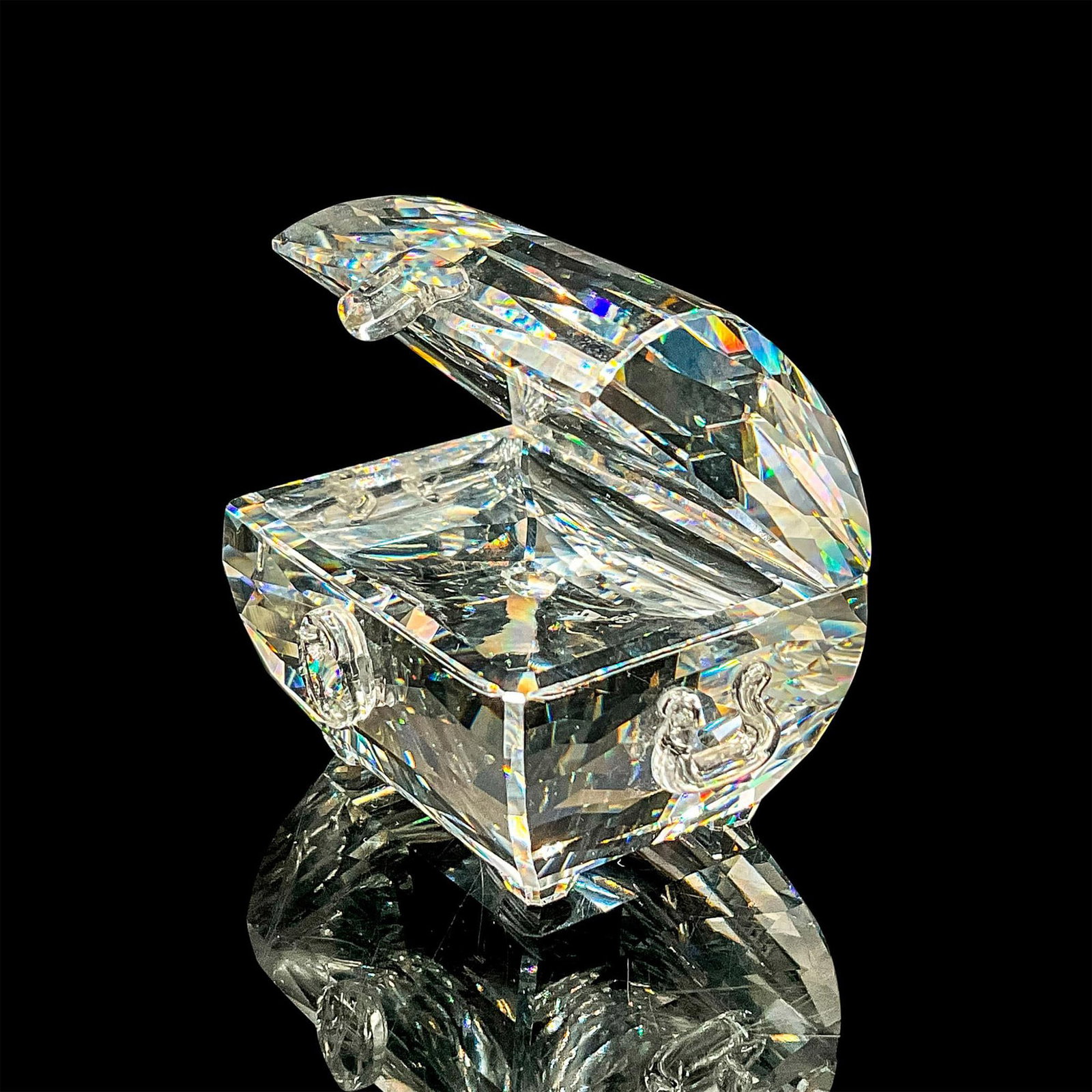 Swarovski Crystal Figurine, Treasure Chest: Brilliant clear crystal figure of an open treasure chest. Swarovski etched mark. Includes original box 4.25"L x 4.25"W x 2.5"H. Dimensions: 1.75"L x 1.25"W x 1.5"H Manufacturer: Swarovski Country of O