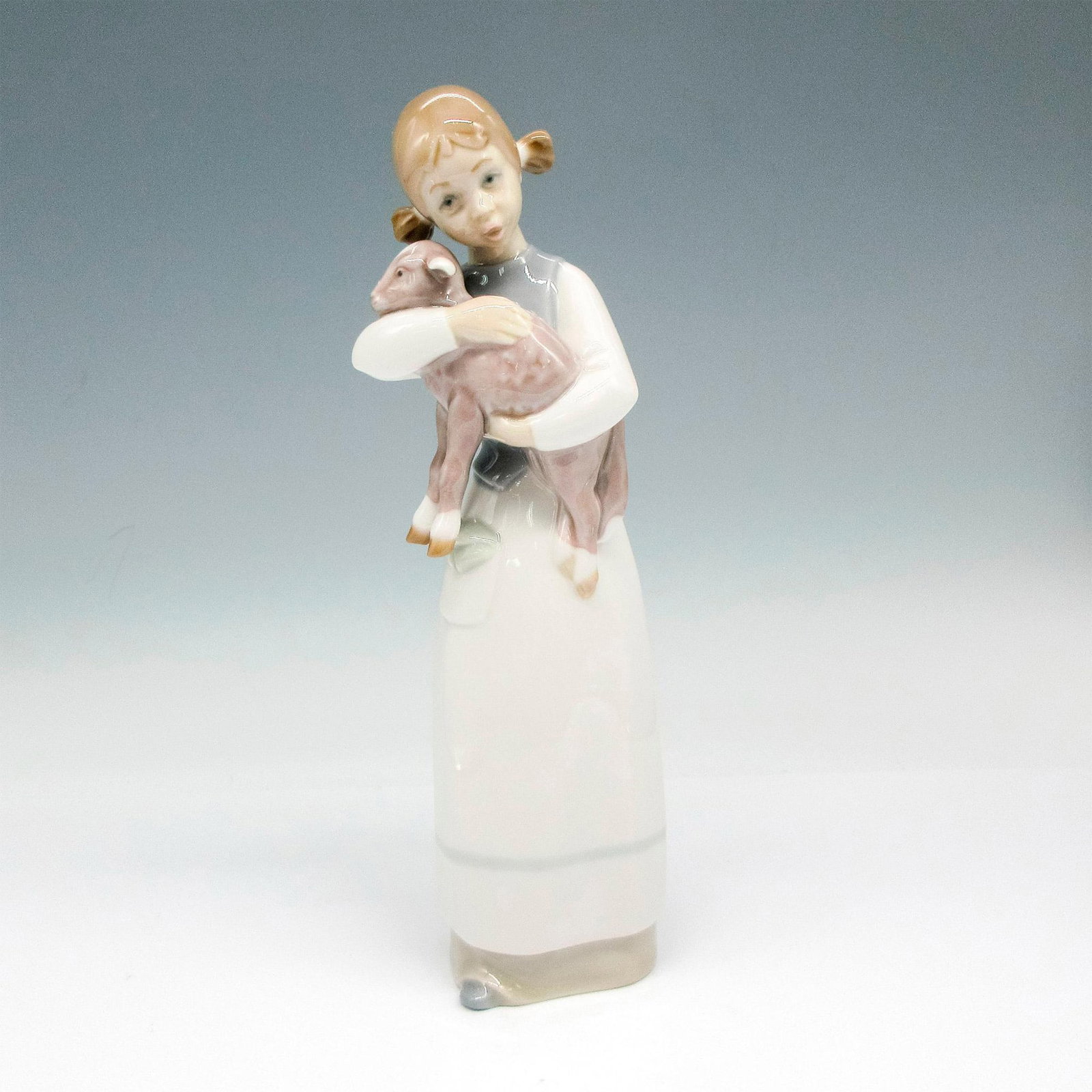 Girl With Lamb 1001010 - Lladro Porcelain Figurine: Glossy finish; Lladro backstamp. Artist: Julio Fernandez Issued: 1969 - 1993 Dimensions: 8.75"H x 3.25"W Manufacturer: Lladro Country of Origin: Spain Condition Age related