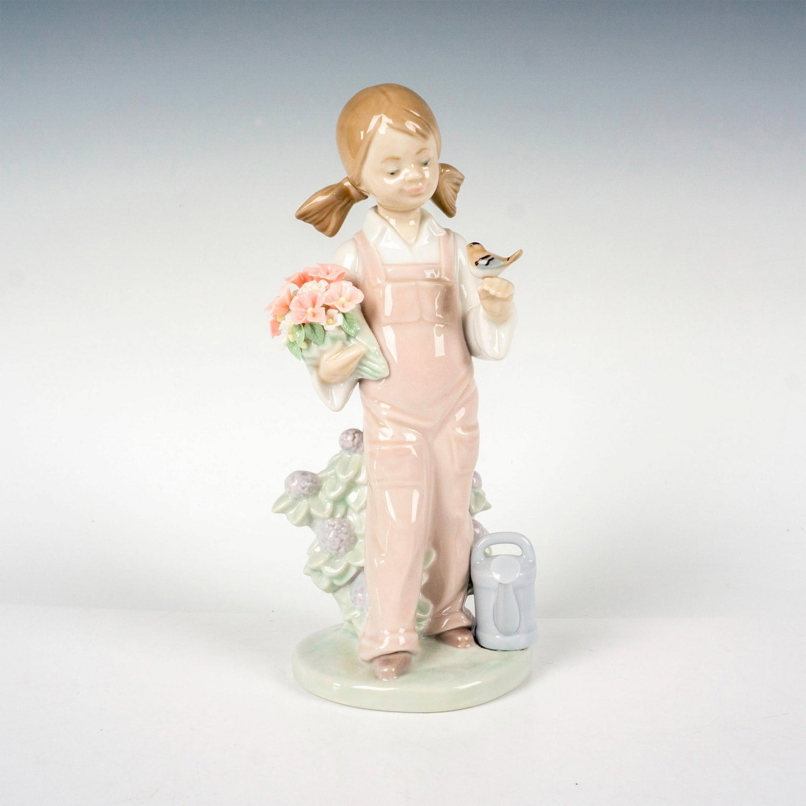 Spring 1005217 - Lladro Porcelain Figurine: Glossy finish; Lladro backstamp. Includes original box. Box measures: 10"L x 5.25"W x 5"H. Artist: Juan Huerta Issued: 1984 Dimensions: 7.5"H x 3.25"W Manufacturer: Lladro Country of Origin: Sp