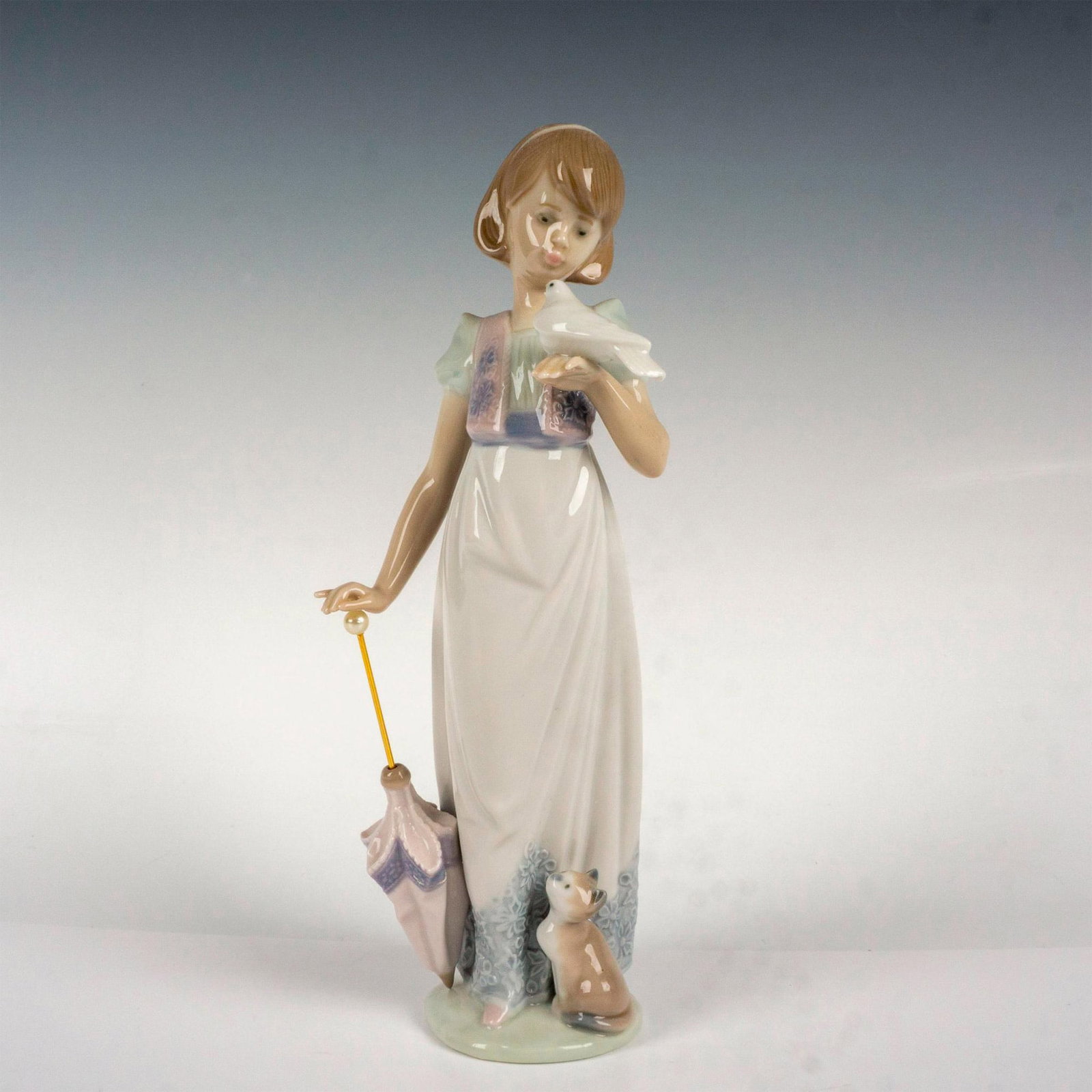 Summer Stroll 1007611 - Lladro Porcelain Figurine: Glossy finish; Lladro backstamp. Artist: Juan Huerta Issued: 1991 - 1991 Dimensions: 9.5"H x 3.25"W Manufacturer: Lladro Country of Origin: Spain Condition Age related wear