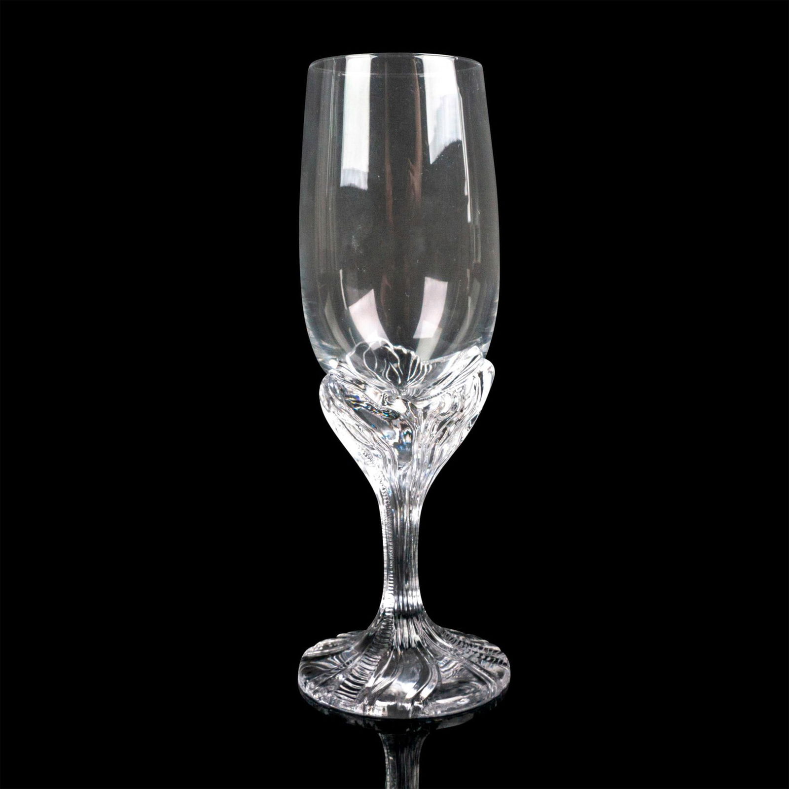 Daum Crystal Champagne Flute, Helianthe: Champagne flute featuring a clear bowl and a stem/foot swirled with captivating texture. Daum, France backstamp. Dimensions: 7.5"H x 2.75"dia. Manufacturer: Daum Country of Origin: France Condition</
