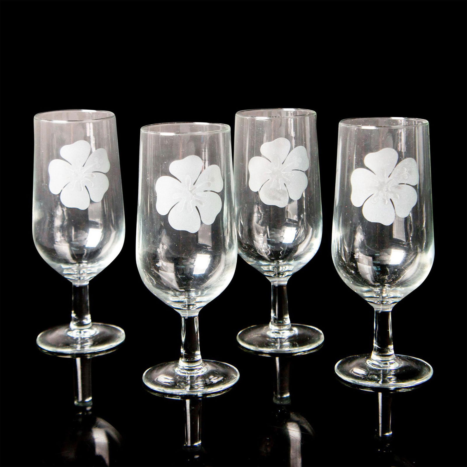 4pc Vintage French Glass Water Goblets: A set of 4 stem drinkware decorated with a frosted hibiscus flower. France embossed on the bases. Dimensions: 2.75”W x 6.75”H Country of Origin: France Condition Age related wear.