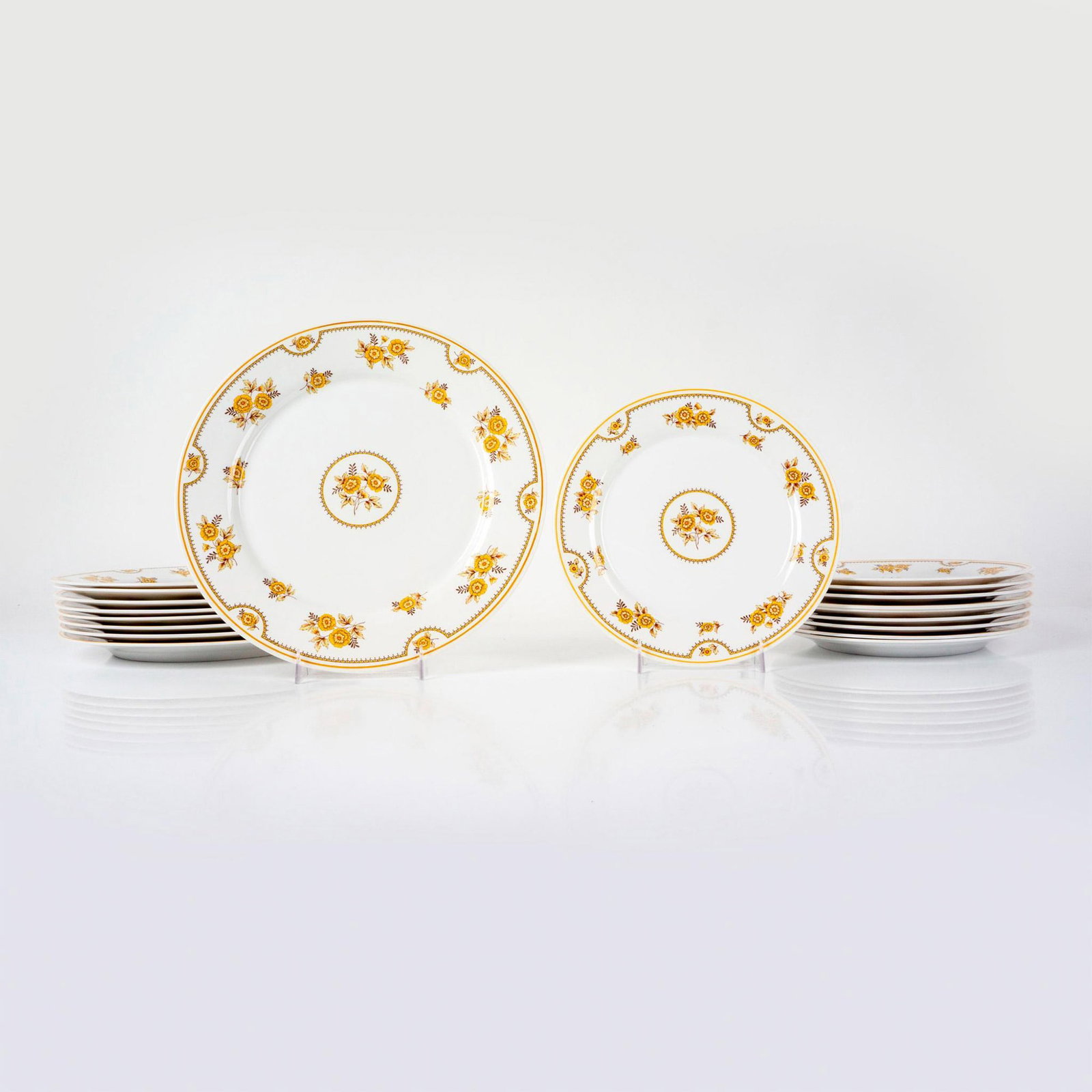 19pc Spode Dinnerware Plates, Austen: Bone china decorated with orange, brown, yellow flowers and bands on white ground with orange rim. Includes 10 bread and butter plates and 9 dinner plates. Largest plates measure: 10.5”dia. Smal