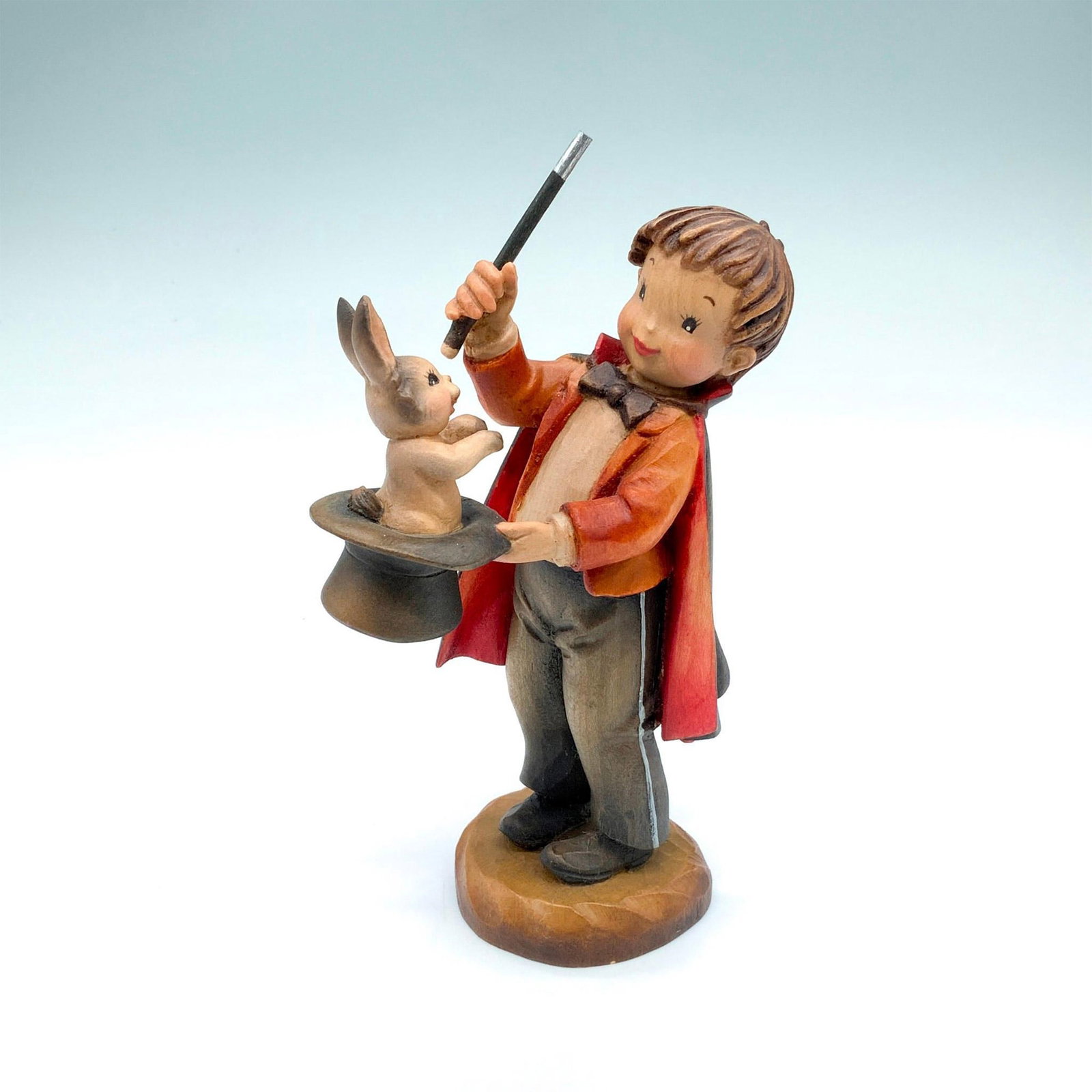 Anri Wooden Figurine, Abracadabra: Wood carving of a little magician pulling a rabbit out of his top hat. A hand painted item with carved details to depict life-like features. Anri backstamp. Artist: Juan Fernandez Issued: c. 1980 - 19