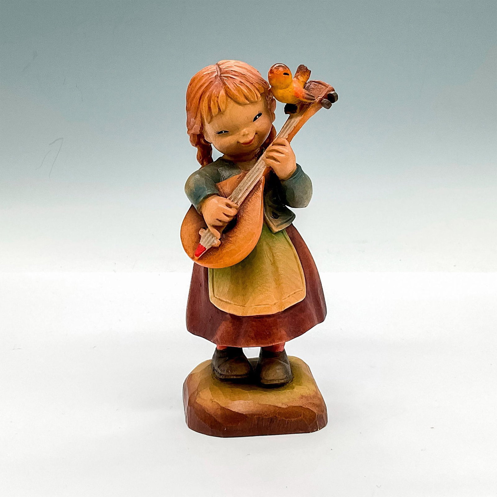 Anri Wooden Figurine, Melody For Two: Hand carved figure of a little girl playing the lute with a bird chirping at her side. Hand painted item. Anri backstamp. Artist: Juan Fernandez Issued: c. 1980 - 1987 Dimensions: 2.75"L x 2.75"W x 6.
