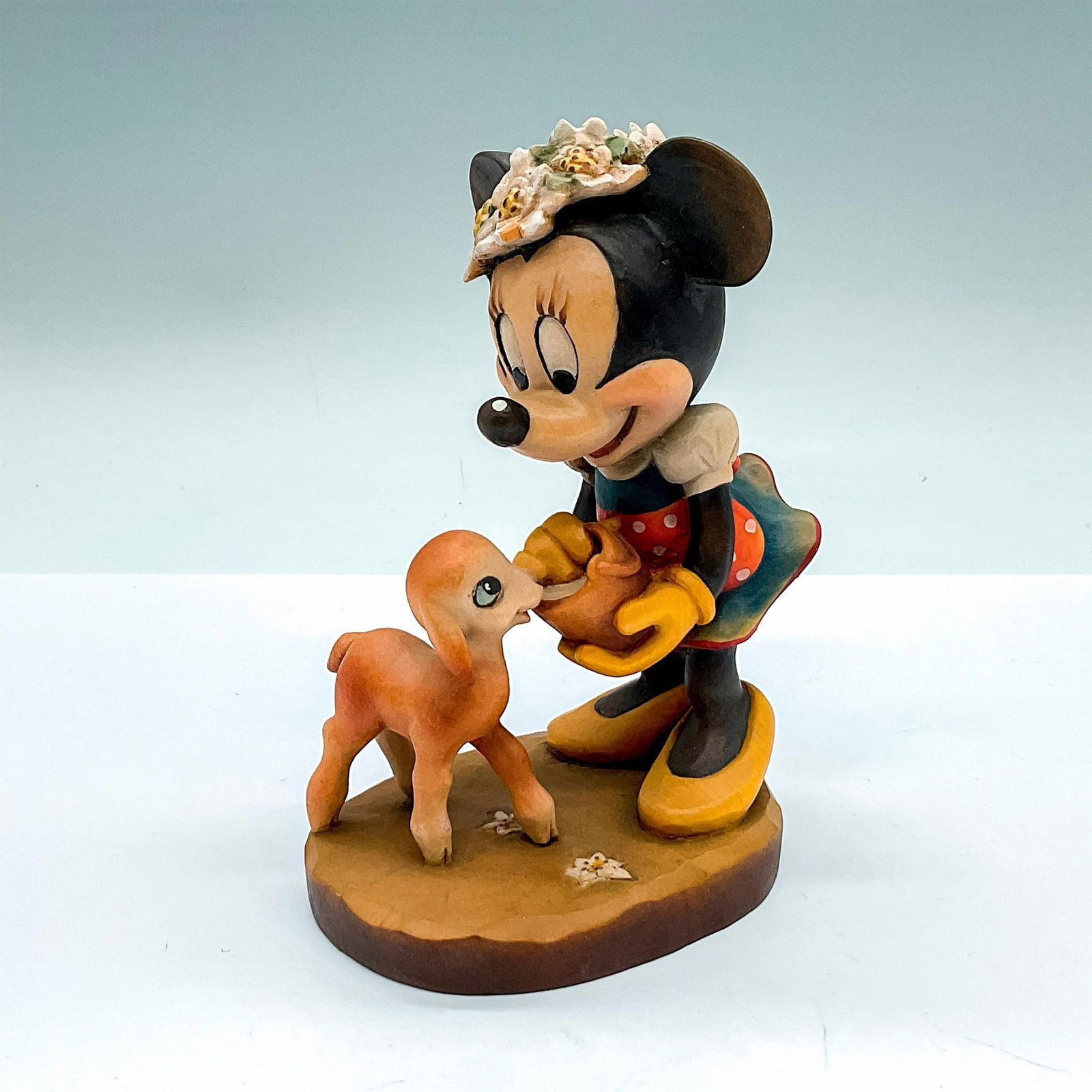 Anri Walt Disney Wooden Figurine, Minnie Mouse: Limited edition. A vintage carved figure of Minnie Mouse feeding a deer. Limited edition number 352/500 carved on the underside. Anri embossed stamp and Walt Disney backstamp on the base. Issued: 20th