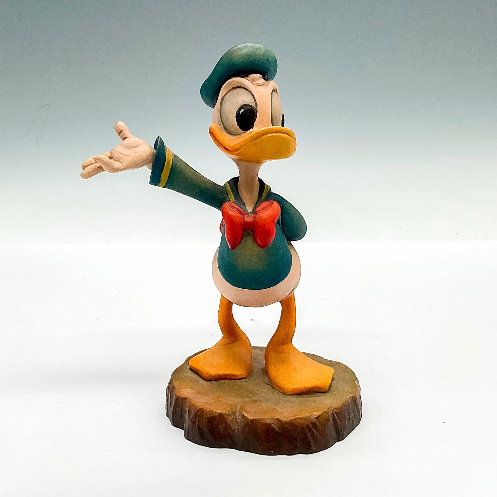 Anri Walt Disney Wooden Figurine, Donald Duck: A carving of the beloved Walt Disney character Donald with one arm out and one behind his back. A hand carved and hand painted piece. Anri and The Walt Disney Company backstamps. Issued: 1982 Dimensio