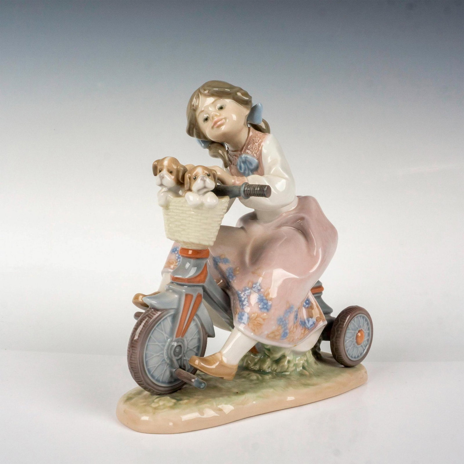 Traveling In Style 1005680 - Lladro Porcelain Figurine: Glossy finish; Lladro backstamp. Artist: Francisco Polope Issued: 1990 - 1994 Dimensions: 6.5"H Manufacturer: Lladro Country of Origin: Spain