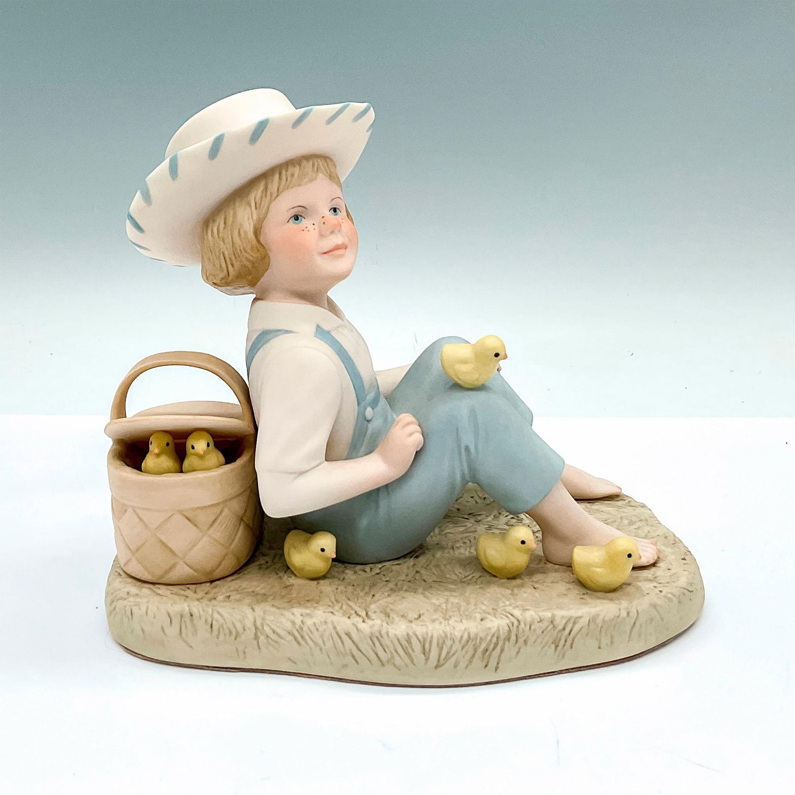 Cybis Porcelain Figurine, Little Jamie: Also known as Jamie Boy with Chicks. Hand painted figure of a boy surrounded by adorable chicks. Cybis markings. Issued: c. 1981-1984 Dimensions: 7.25"L x 4.25"W x 6.25"H Manufacturer: Cybis Country o
