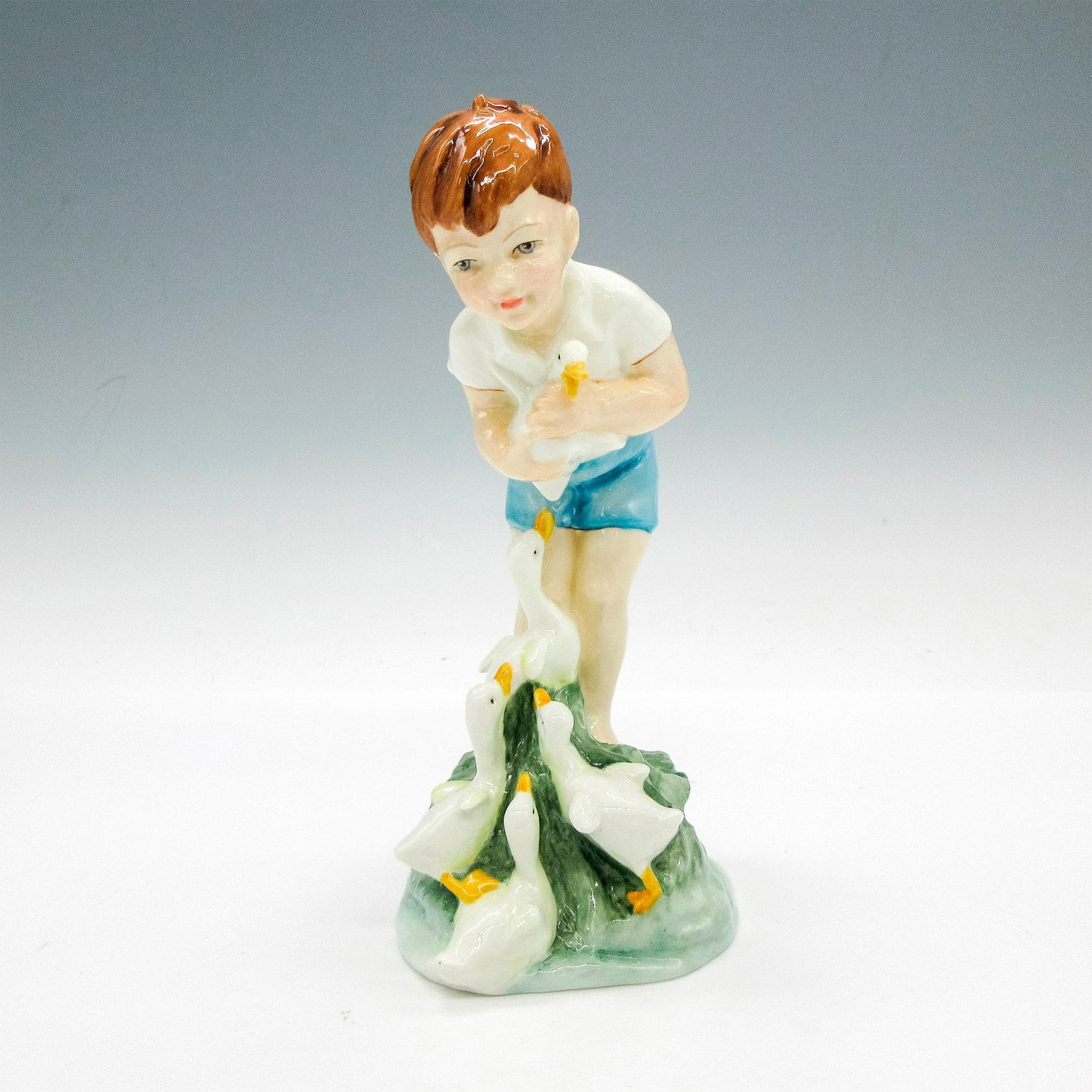 Royal Worcester Bone China Figurine, Young Farmer: Adorable glazed figural with baby ducks. Royal Worcester backstamp. 3433. D. Ball Signed. Artist: F.G. Doughty Issued: c. 1980 Dimensions: 2.75"L x 3.25"W x 7"H Manufacturer: Royal Worcester Country