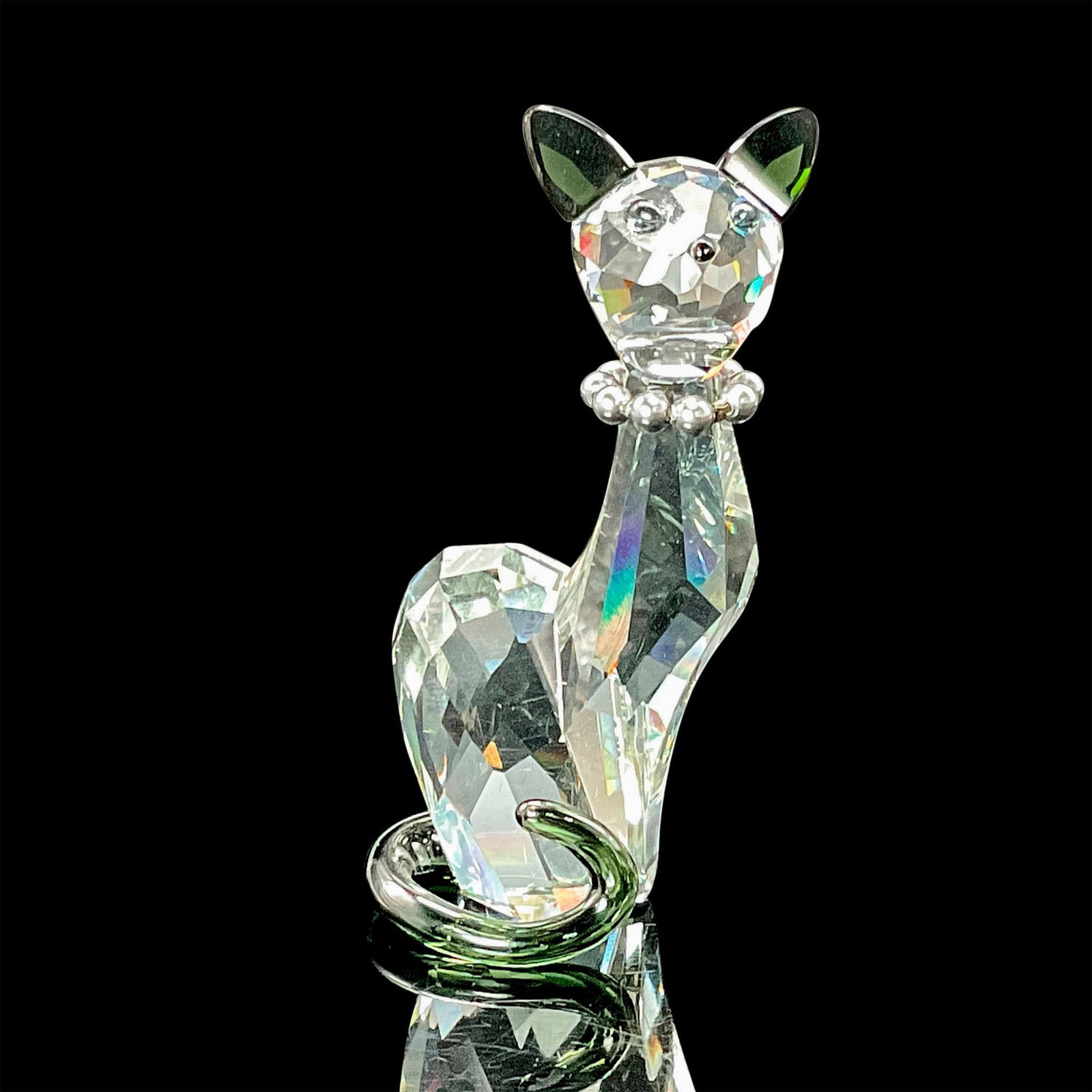 Swarovski Crystal Figurine, Lovlots House of Cats Ines: Ines, a chic addition to the House of Cats family, shines in Shadow crystal, with her ears and tail in the rich hues of Morion crystal. Her aquamarine blue crystal eyes, adorned with black pupils, spa