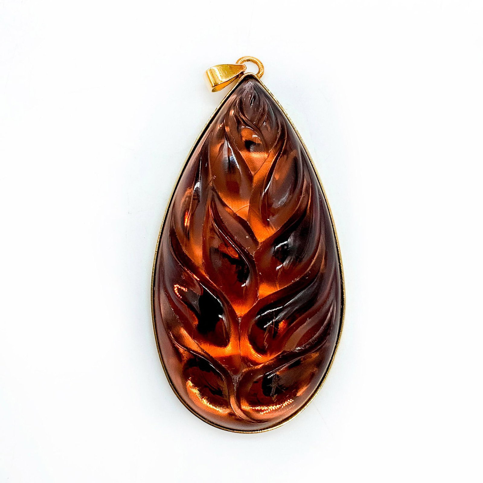Lalique Crystal Heliconia Brown Leaf Pendant: Inspired by the tropical Heliconia plants of the Caribbean. Marked Lalique France on gold plated back. Dimensions: 2.5"L x 1.25"W Country of Origin: France Manufacturer: Lalique Provenance: Collection