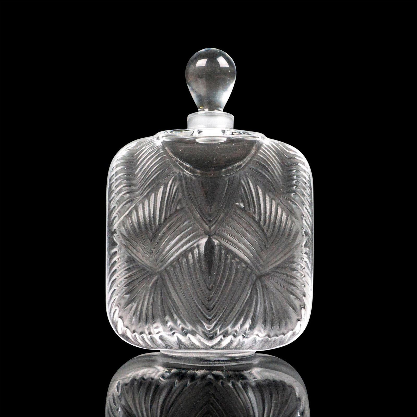Lalique Crystal Perfume Bottle, Hittite: A frosted and clear vessel with geometric pattern and teardrop shaped stopper. Lalique France etched backstamp. Dimensions: 2.5"L x 1"W x 3.5"H Country of Origin: France Manufacturer: Lalique