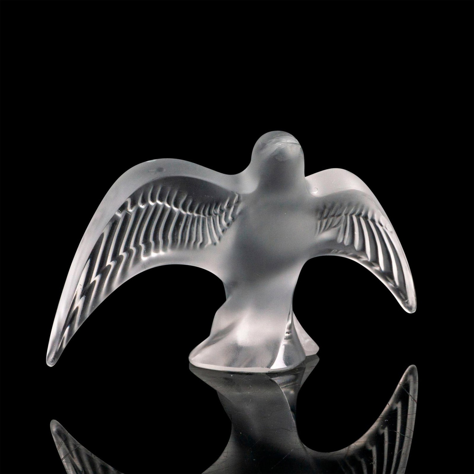 Lalique Crystal Figurine, Taking Flight Swallow: A fogged crystal figure of a swallow with its wings outspread taking flight from a crystal perch. Signed Lalique France. Dimensions: 6"L x 4"W x 3"H Country of Origin: France Manufacturer: Lalique