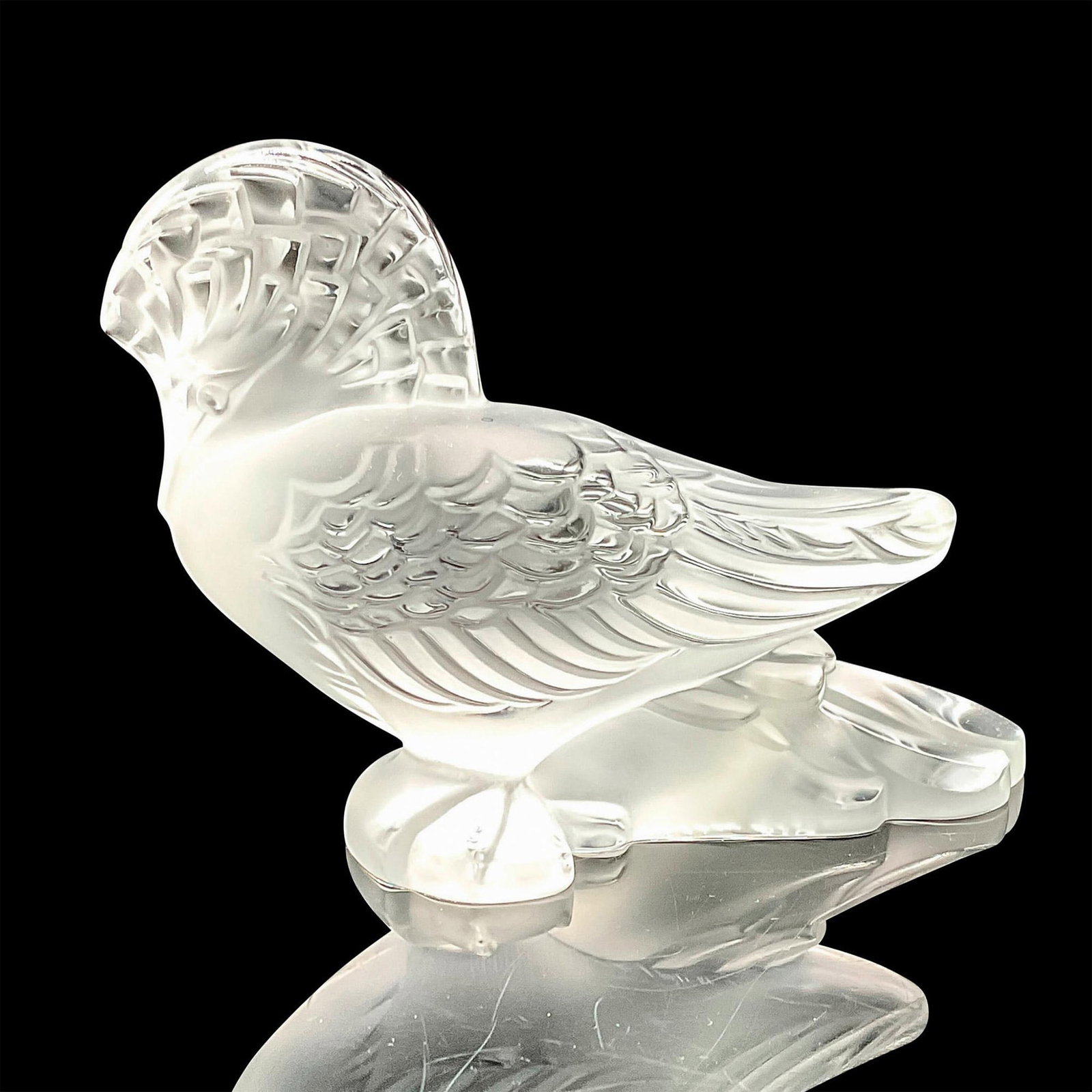 Lalique Crystal Figurine New Guinea Goura: a stunning depiction of this magnificent bird, crafted with precision in crystal, capturing its beauty and elegance in exquisite detail. Dimensions: 4.75"L x 2.25"W x 3.25"H Country of Origin: France 