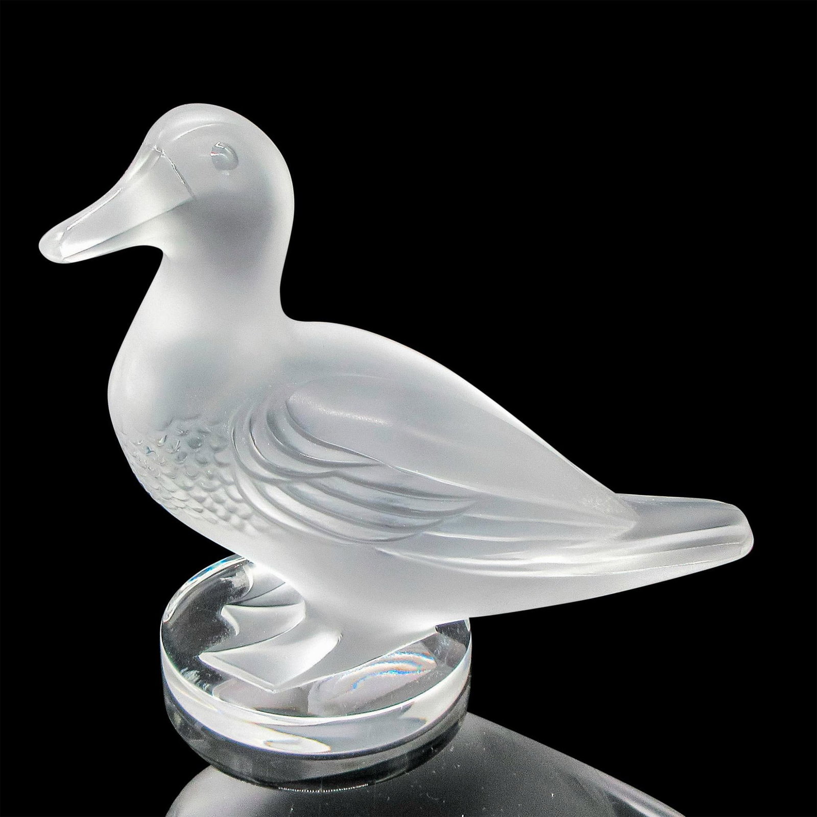 Lalique Frosted Crystal Paperweight, Canard Debout: Frosted standing figural has textured breast, defined wings with webbed feet on clear round base. Lalique etched mark. Dimensions: 5.5"L x 2.5"W x 5.5"H Country of Origin: France Manufacturer: Lalique