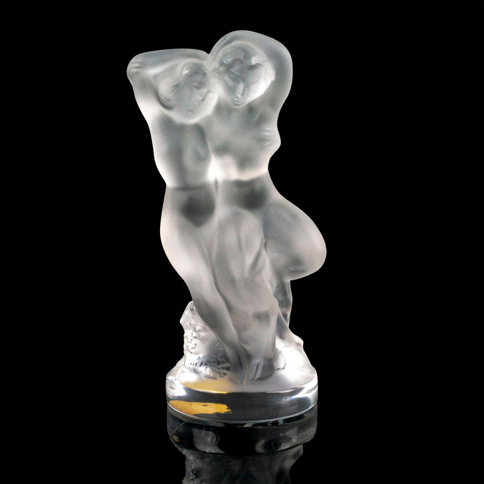 Lalique Crystal Hood Ornament, Pan and Diana: Figure of Pan and Diana in a forest. Originally designed as an automobile hood ornament. Satin finish. Etched Lalique France. Factory sticker at the bottom. Issued: 1960 Dimensions: 2"L x 2.5"W x 4"H 