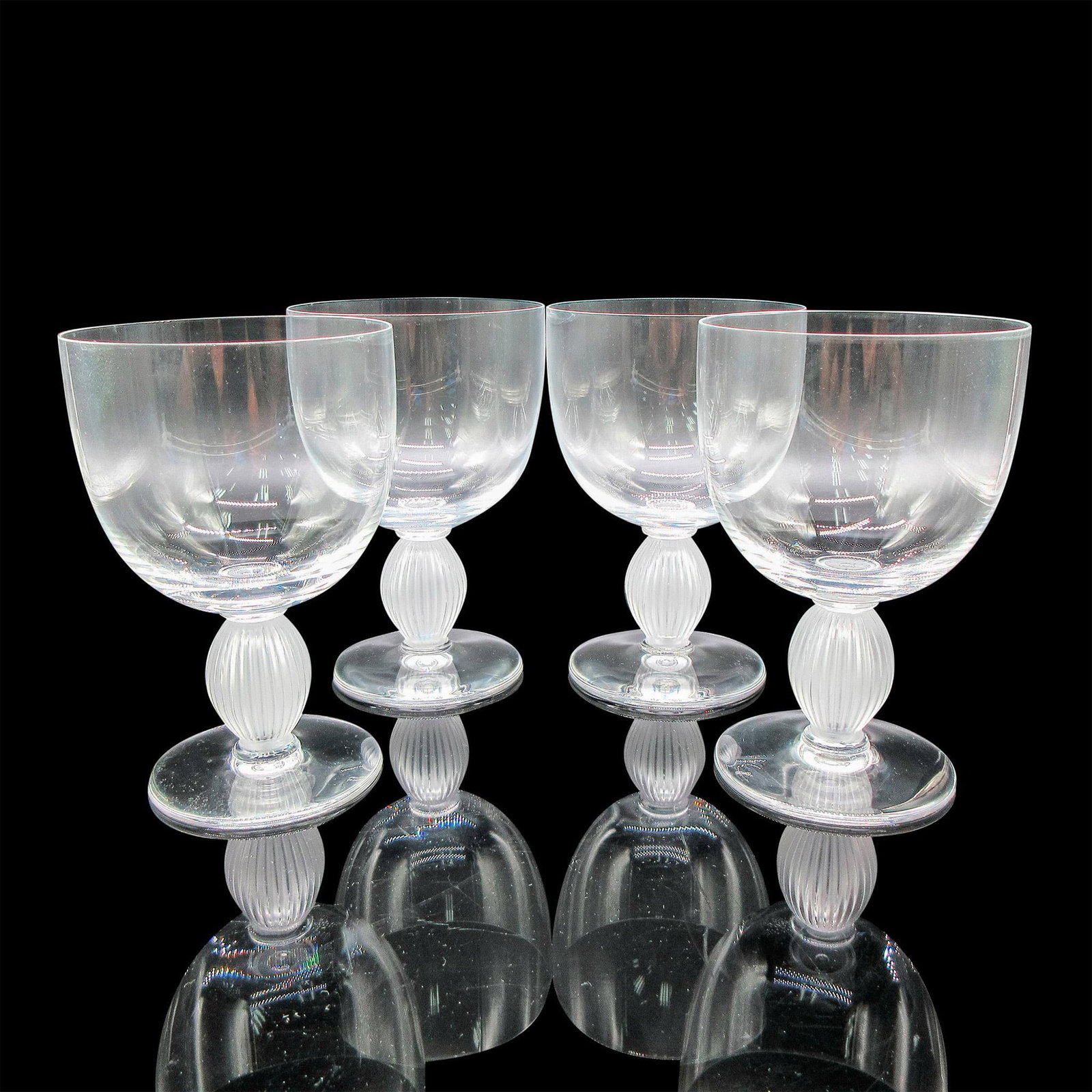 Lalique Crystal Bordeaux Wine Glasses, Langeais: Clear body with frosted vertical ribbed stem. Lalique etched mark. Artist: Marc Lalique Dimensions: 3.25"L x 3.25"W x 5"H Country of Origin: France Manufacturer: Lalique Provenance: Collection of