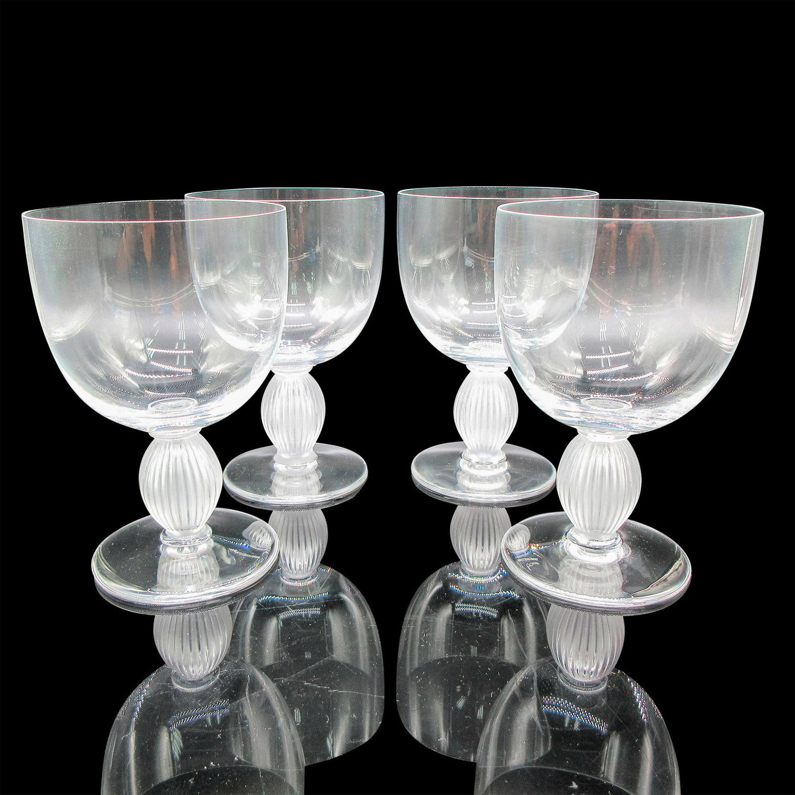 Lalique Crystal Bordeaux Wine Glasses, Langeais: Clear body with frosted vertical ribbed stem. Lalique etched mark. Artist: Marc Lalique Dimensions: 3.25"L x 3.25"W x 5"H Country of Origin: France Manufacturer: Lalique Provenance: Collection of