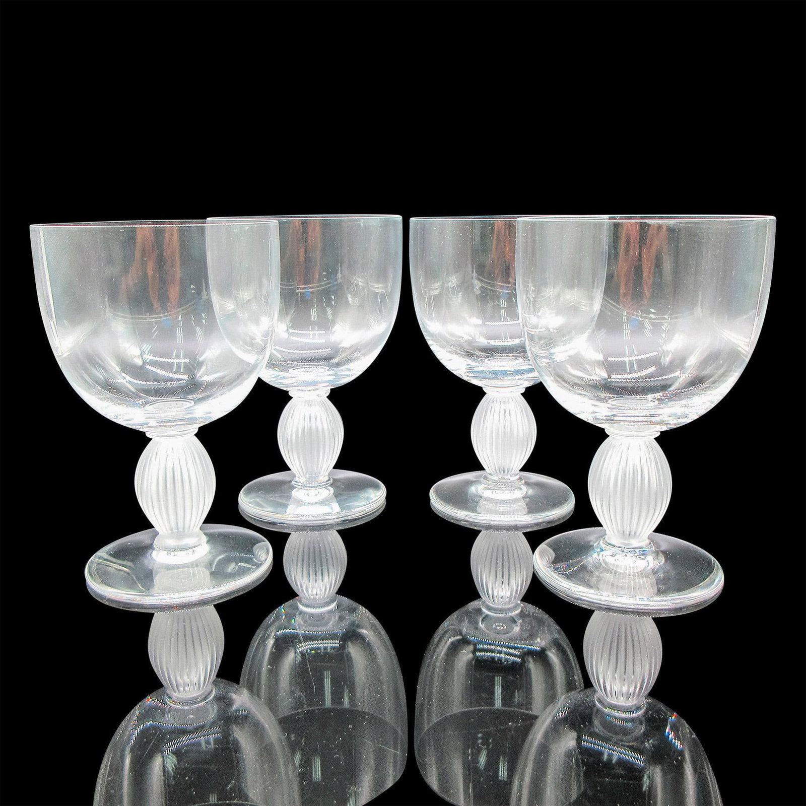 Lalique Crystal Bordeaux Wine Glasses, Langeais: Clear body with frosted vertical ribbed stem. Lalique etched mark. Artist: Marc Lalique Dimensions: 3.25"L x 3.25"W x 5"H Country of Origin: France Manufacturer: Lalique Provenance: Collection of