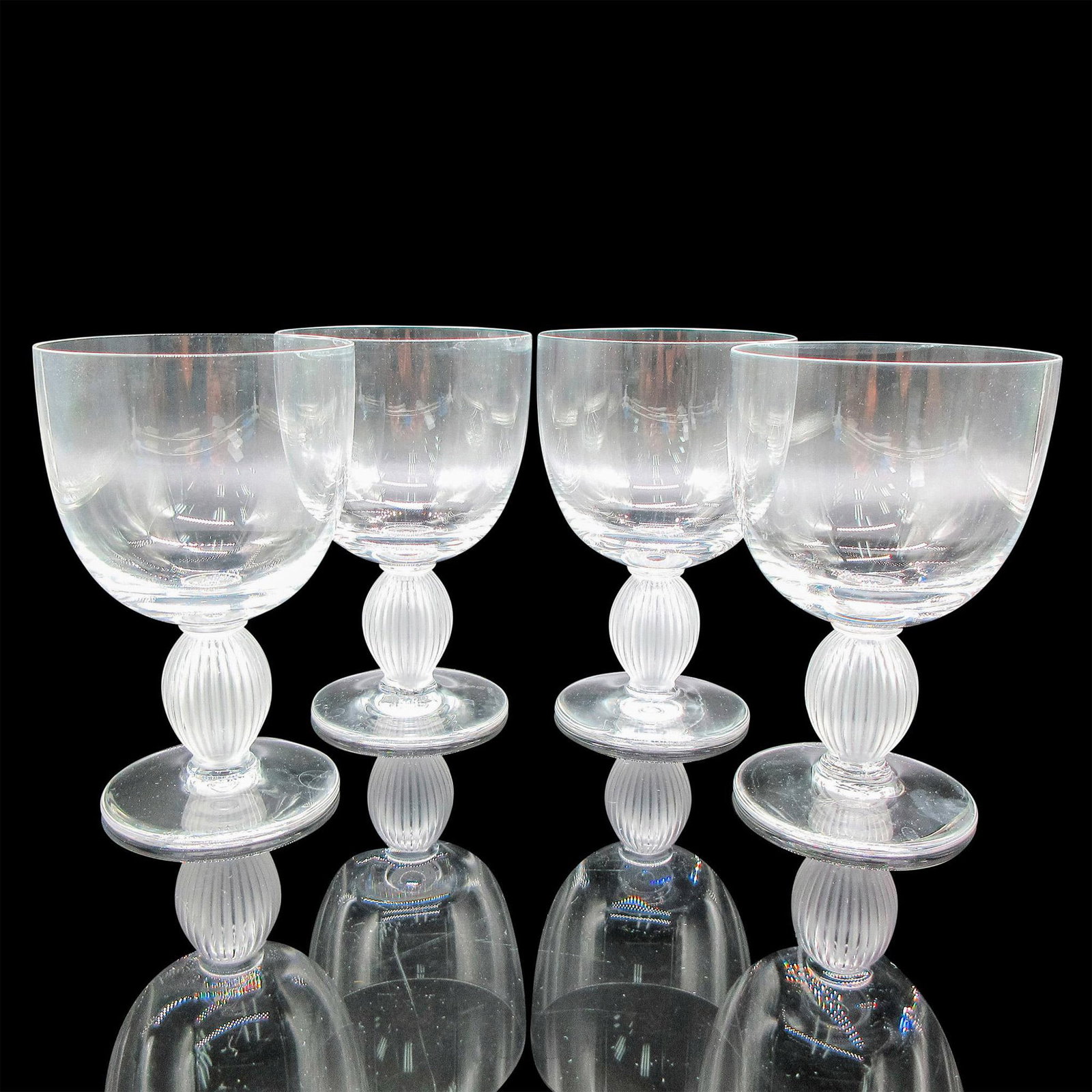 4pc Lalique Crystal Bordeaux Wine Glasses, Langeais: Clear body with frosted vertical ribbed stem. Lalique etched mark. Artist: Marc Lalique Dimensions: 3"L x 3"W x 4.75"H Country of Origin: France Manufacturer: Lalique Provenance: Collection of Ma