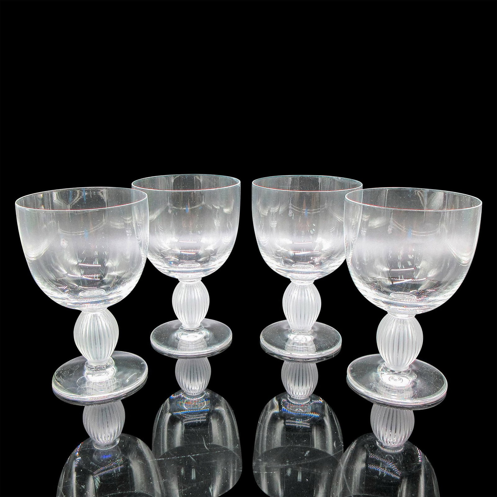 4pc Lalique Crystal Bordeaux Wine Glasses, Langeais: Clear body with frosted vertical ribbed stem. Lalique etched mark. Artist: Marc Lalique Dimensions: 3"L x 3"W x 4.5"H Country of Origin: France Manufacturer: Lalique Provenance: Collection of Mar