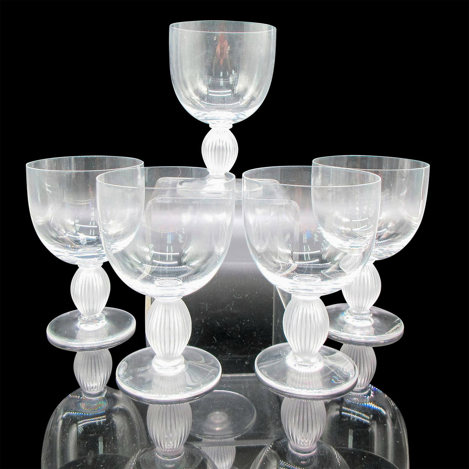5pc Lalique Crystal Bordeaux Wine Glasses, Langeais: Clear body with frosted vertical ribbed stem. Lalique etched mark. Artist: Marc Lalique Dimensions: 3.25"L x 3.25"W x 5"H Country of Origin: France Manufacturer: Lalique Provenance: Collection of