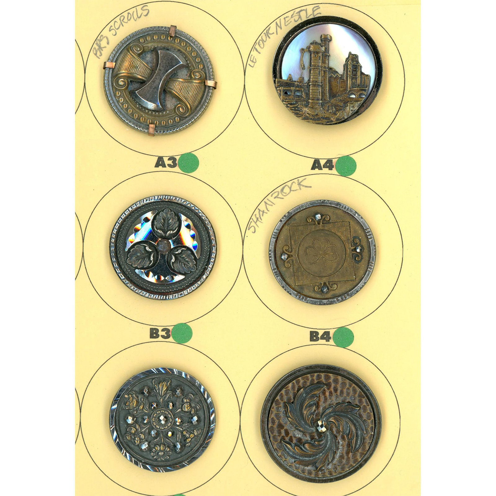 A Small Card of Division One Steel Cup Buttons: 6 Large 19th century steel cups including pearl background. This lot includes the pearl background "Tour de Nestle" castle along with several other fine condition steel cups. From the Nikki Deal colle