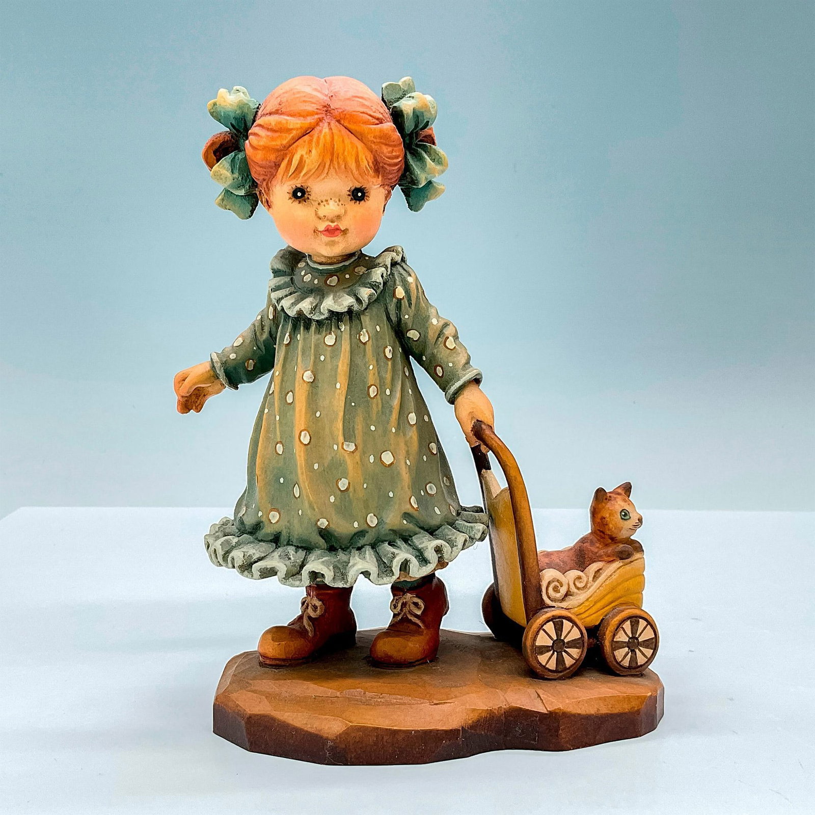 Anri Italy Wood Carved Figurine, Purrfect Day: Sweet painted figure of a young girl pulling a pram holding her cat. In hues of earthy orange, green, tan and brown. Anri metal logo emblem affixed to base. Design Valentine backstamp. Sarah Kay engra